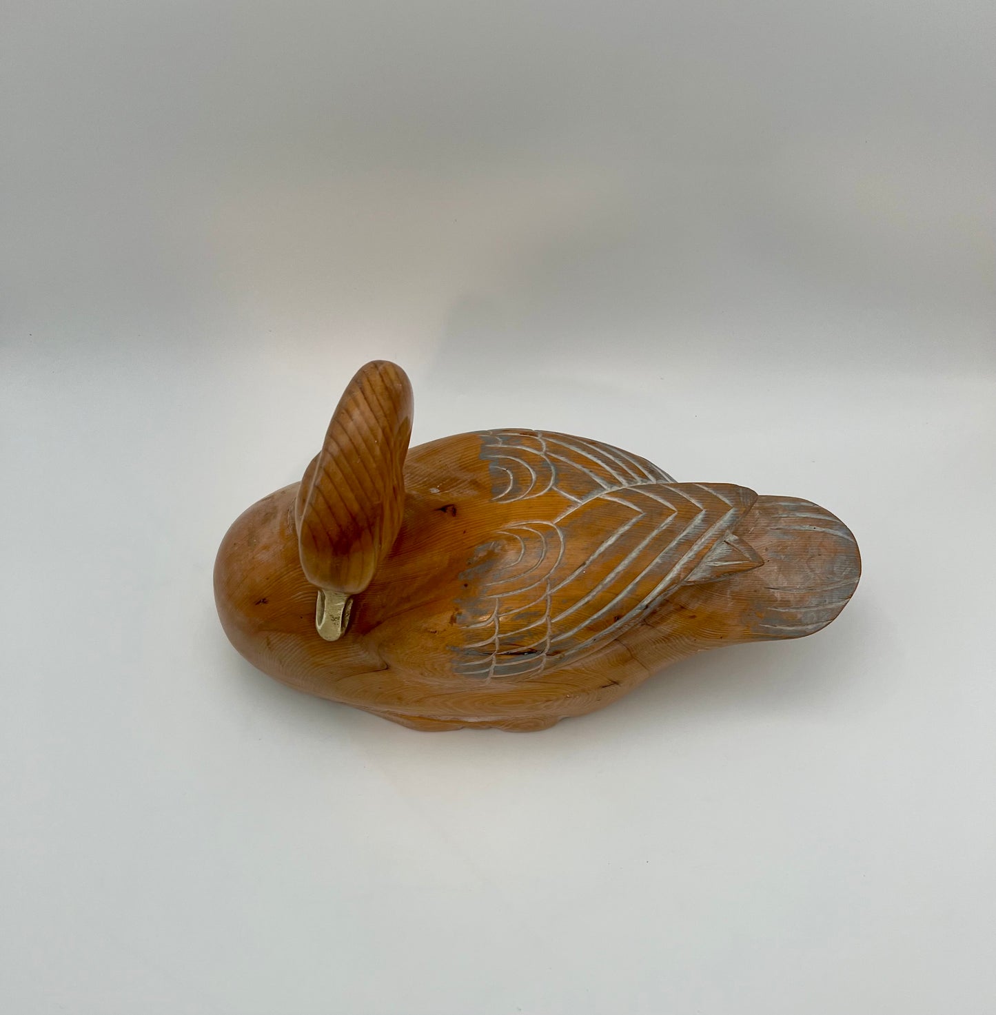WOOD CARVED SLEEPING DUCK HAND PAINTED WITH BRASS DETAIL