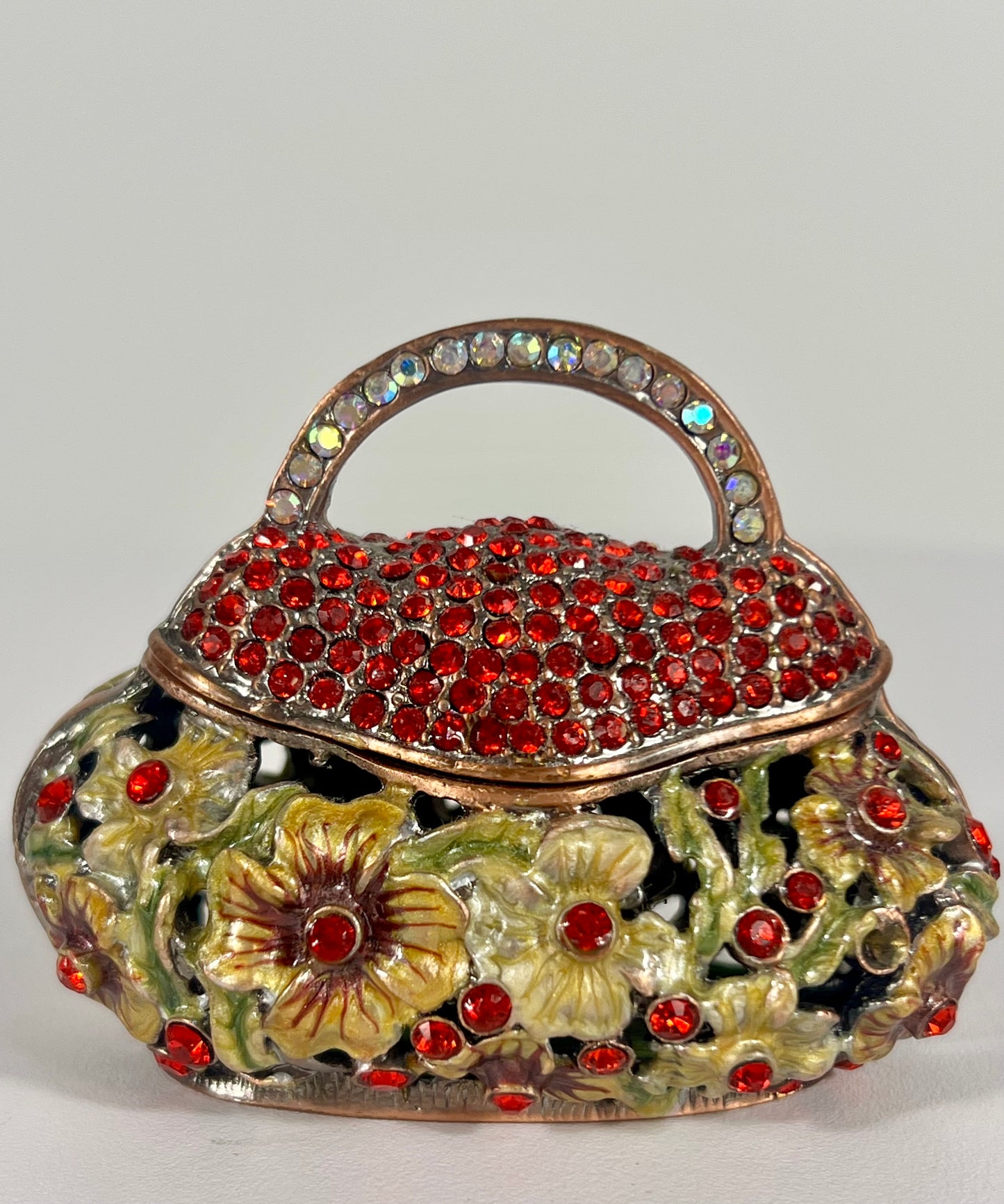 VINTAGE SMALL TRINKET/JEWELRY BOX PURSE SHAPED WITH CUT OUT FLOWERS AND RED CRYSTALS