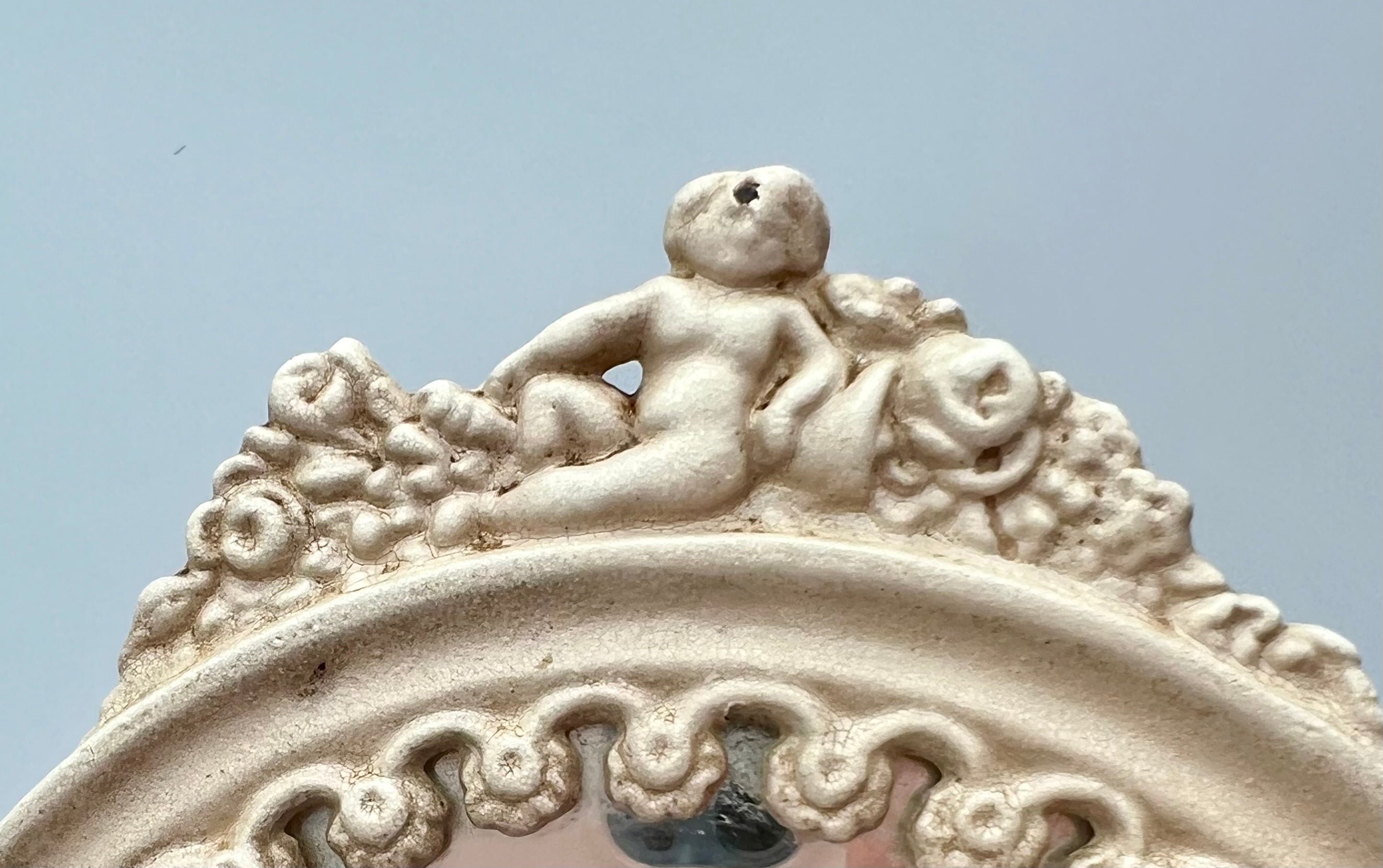 ANTIQUE VANITY TABLE MIRROR WITH DOG HEAD HANDLES & PUTTO CHERUB – ORNATE CAST IRON – 14 ¾ INCH – CIRCA EARLY 1900s