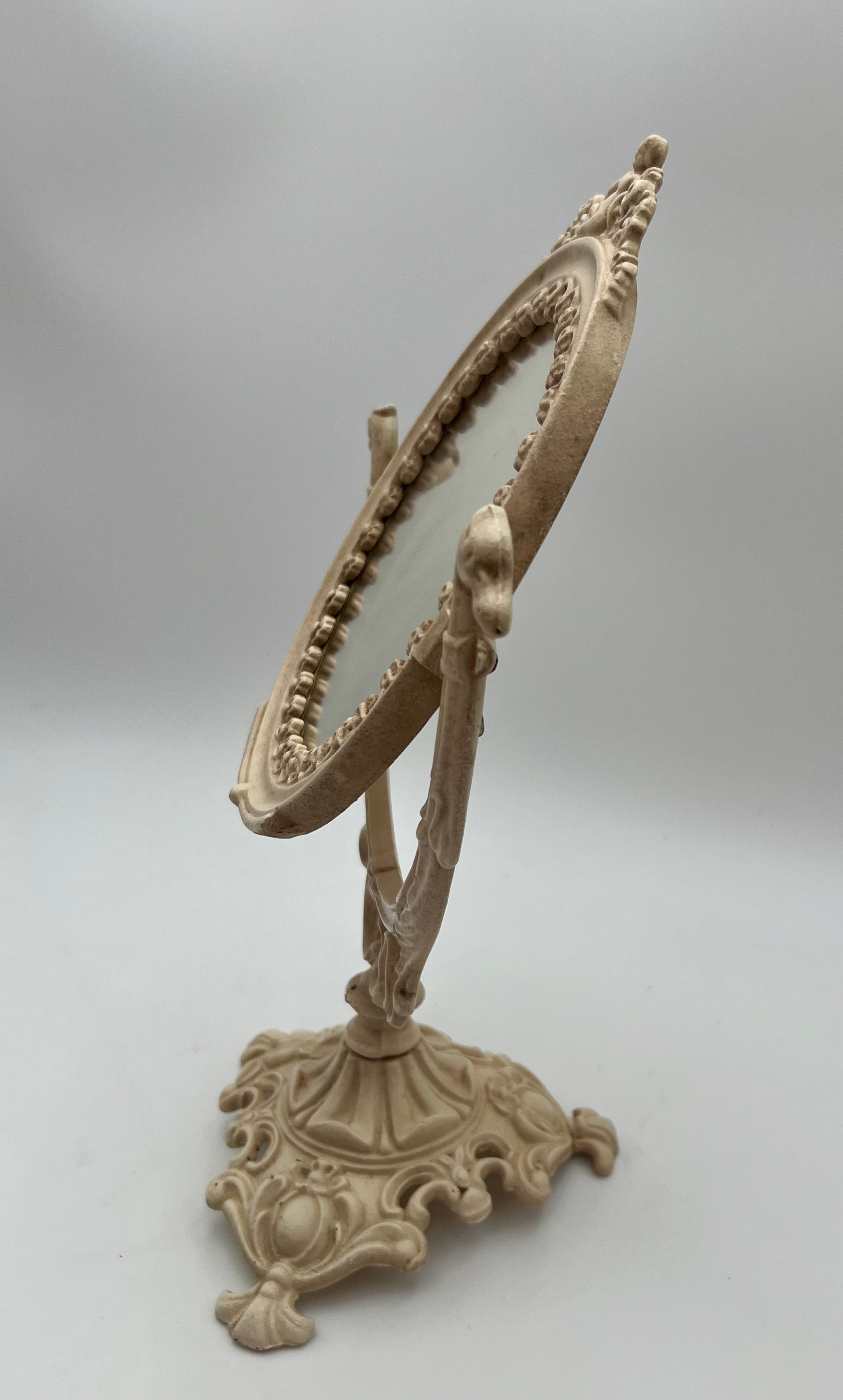 ANTIQUE VANITY TABLE MIRROR WITH DOG HEAD HANDLES & PUTTO CHERUB – ORNATE CAST IRON – 14 ¾ INCH – CIRCA EARLY 1900s