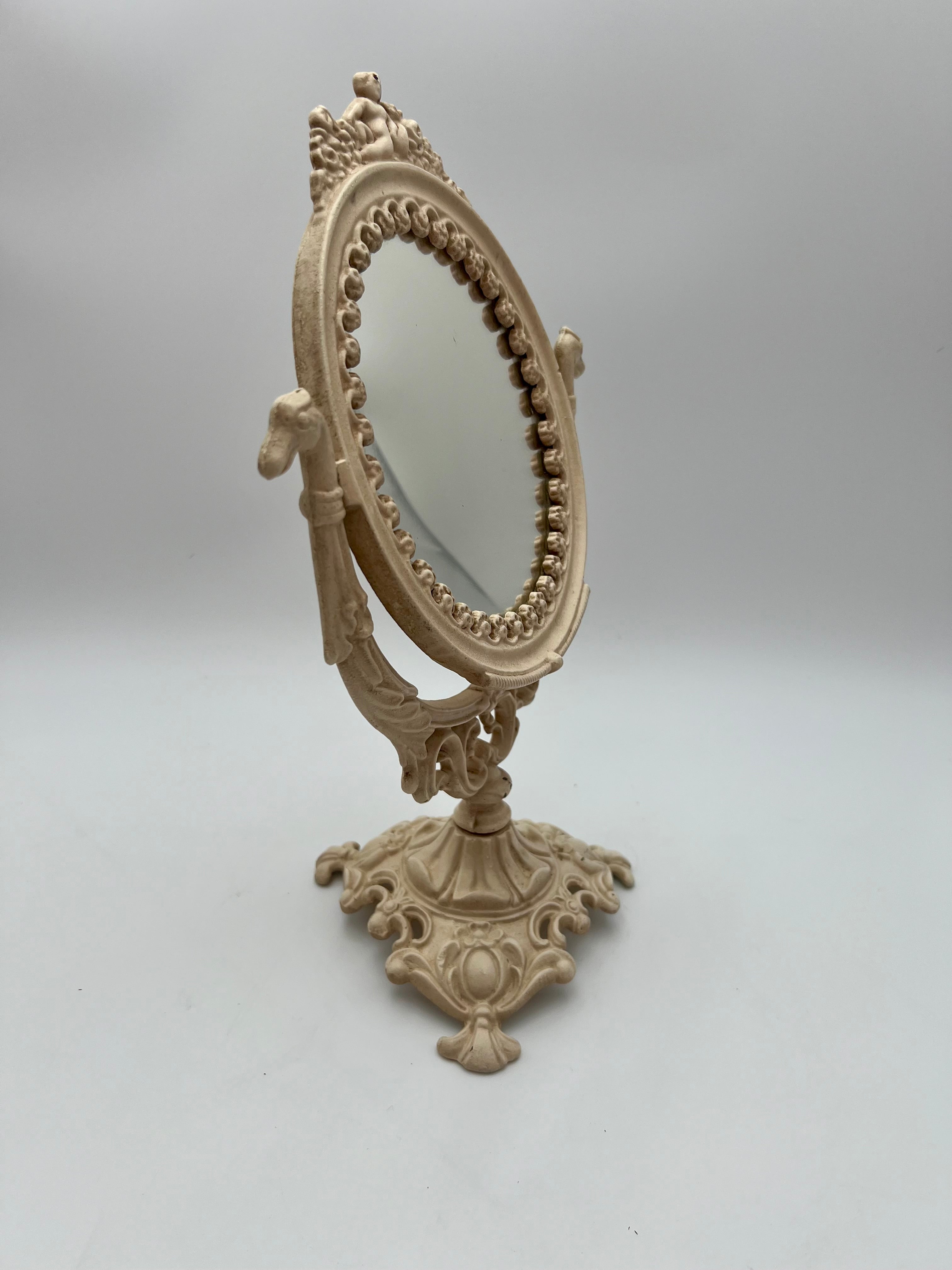 ANTIQUE VANITY TABLE MIRROR WITH DOG HEAD HANDLES & PUTTO CHERUB – ORNATE CAST IRON – 14 ¾ INCH – CIRCA EARLY 1900s