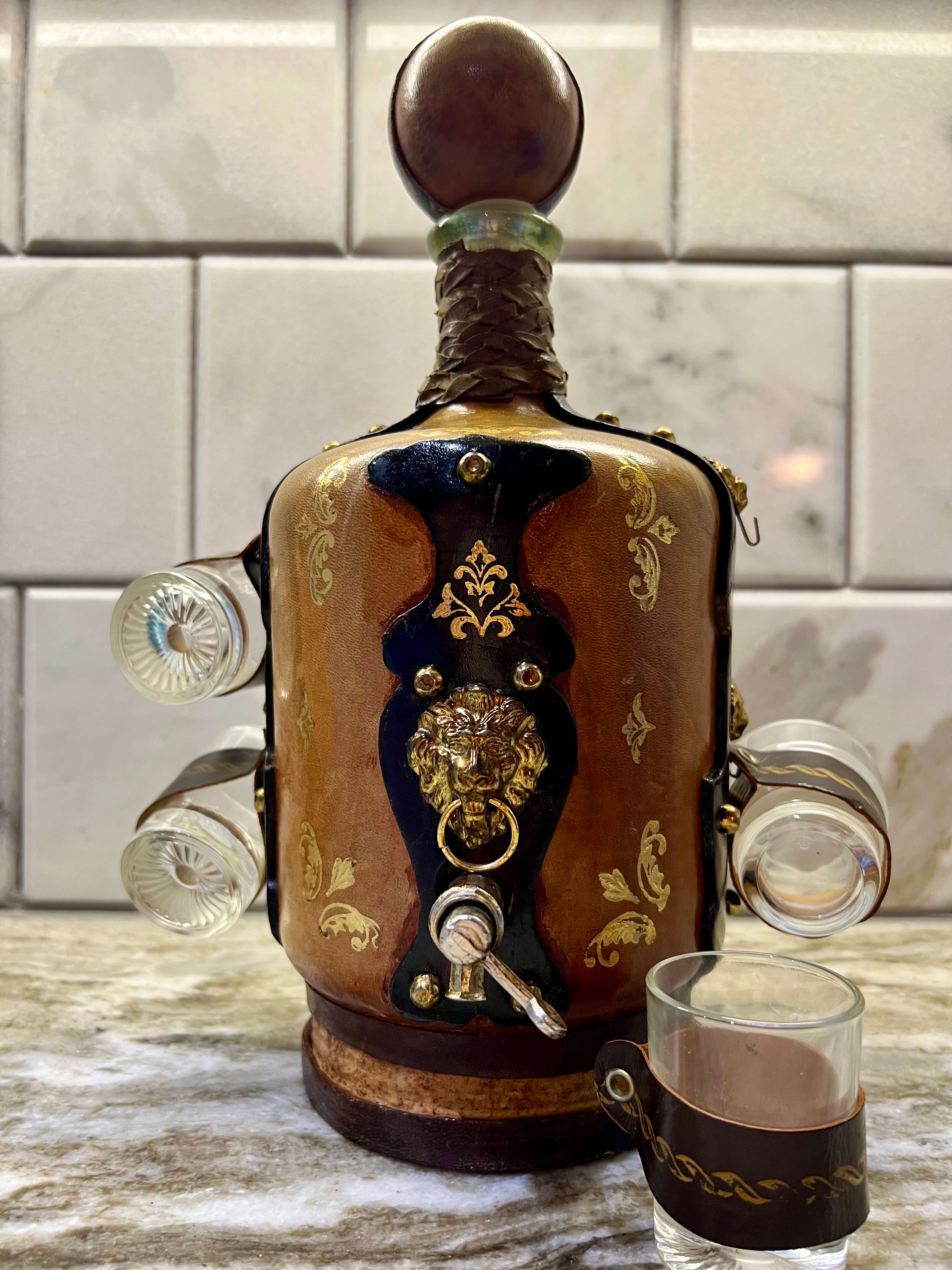 VINTAGE ITALIAN LEATHER-WRAPPED DECANTER SET WITH LION SPIGOT