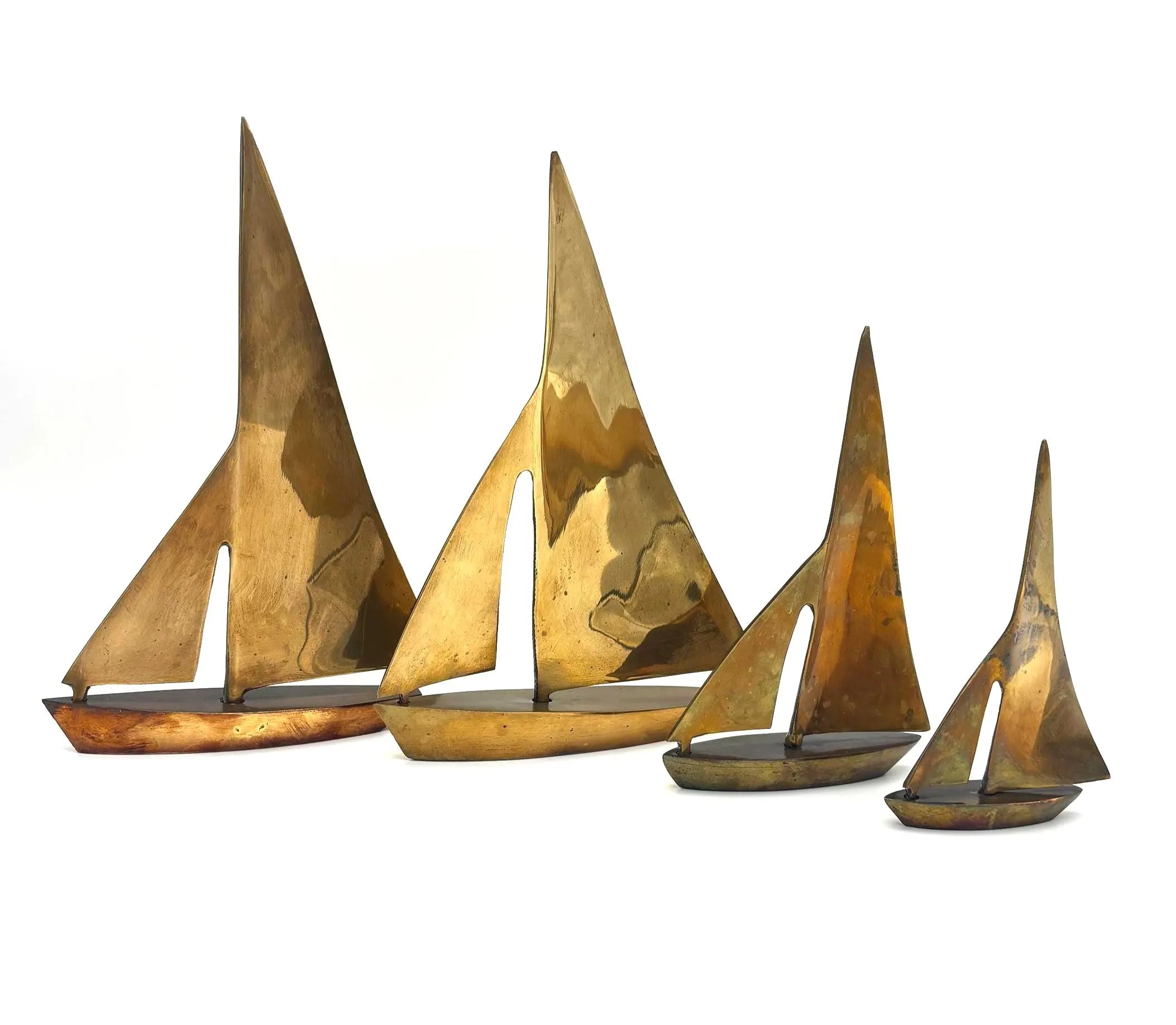 VINTAGE SOLID BRASS SAILBOAT SCULPTURES – COLLECTION OF FOUR MODERNIST YACHTS
