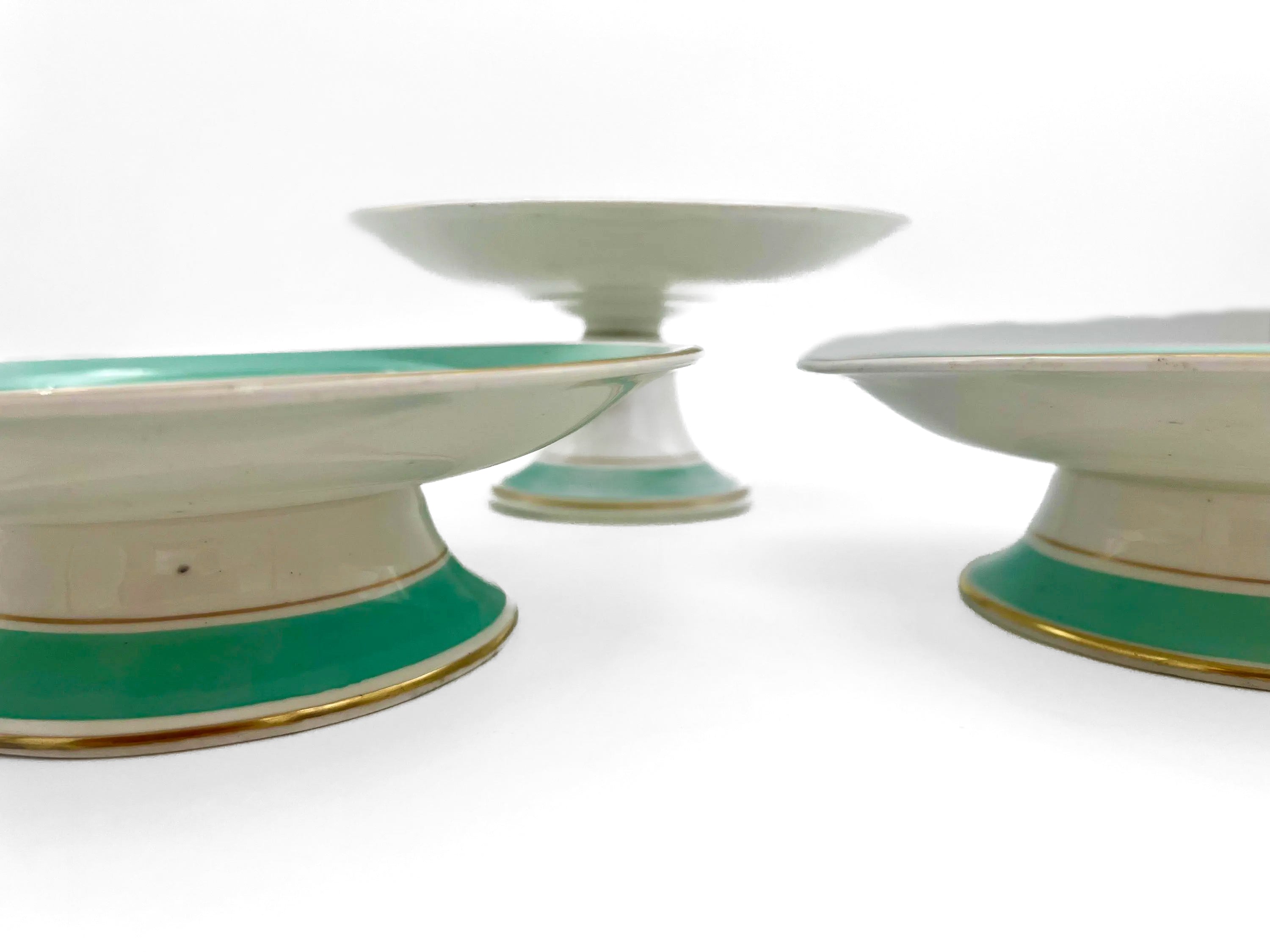 Trio of 1880s English Victorian ceramic compotes featuring hand-painted floral bouquets and pedestal bases.