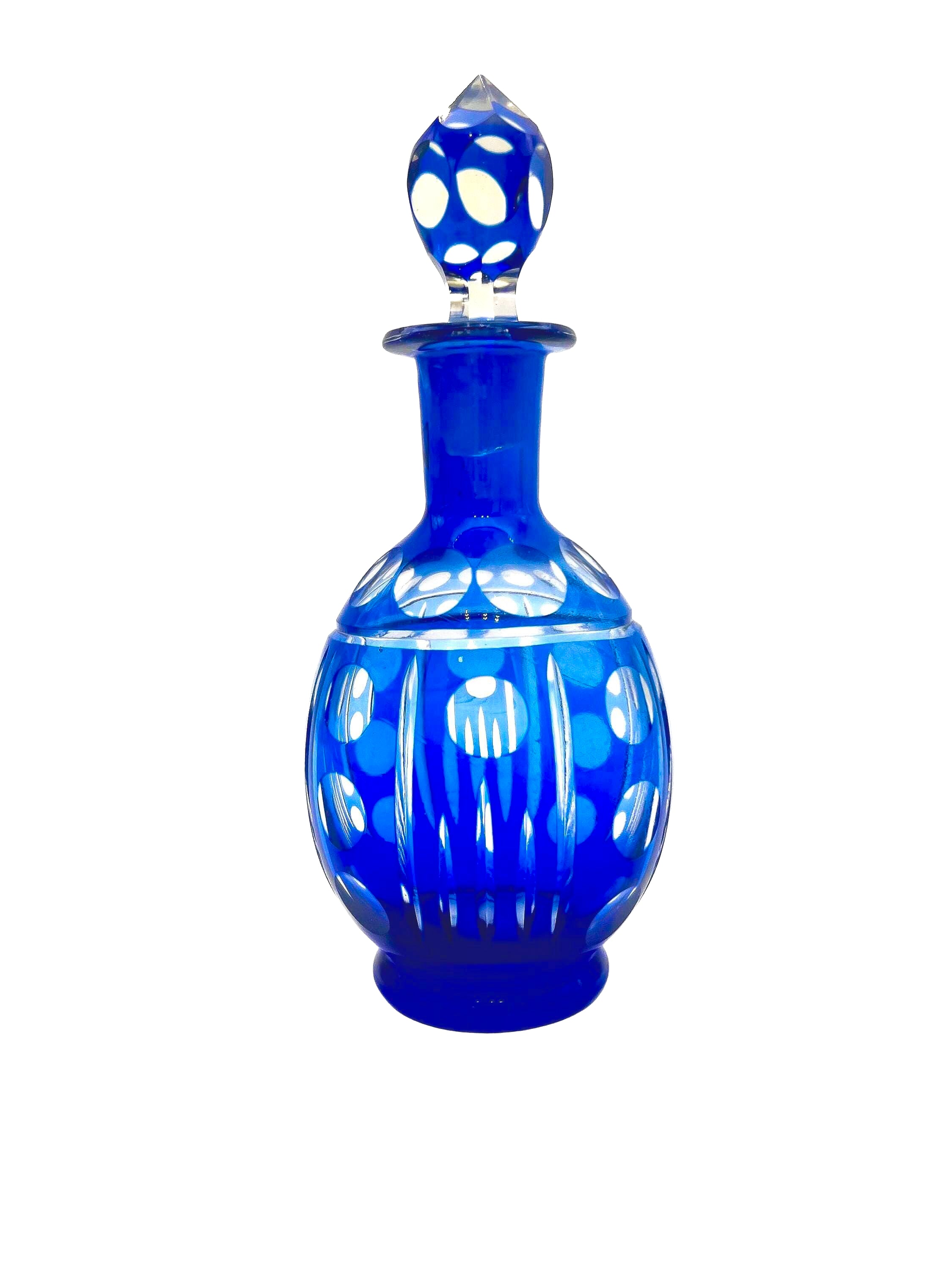 Minimalist mid-century modern decanter in a deep cobalt blue glass with a matching round stopper.