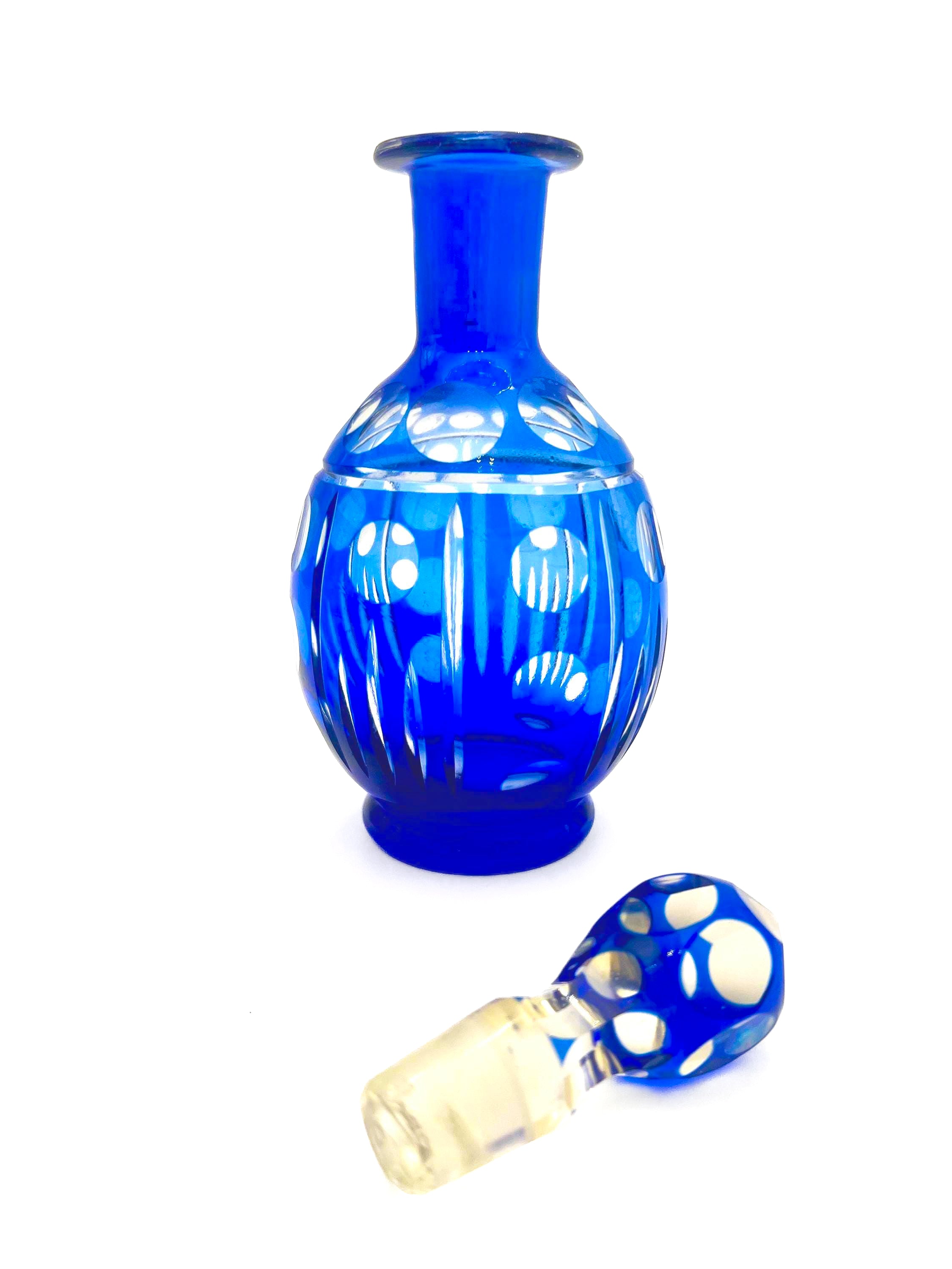 Minimalist mid-century modern decanter in a deep cobalt blue glass with a matching round stopper.