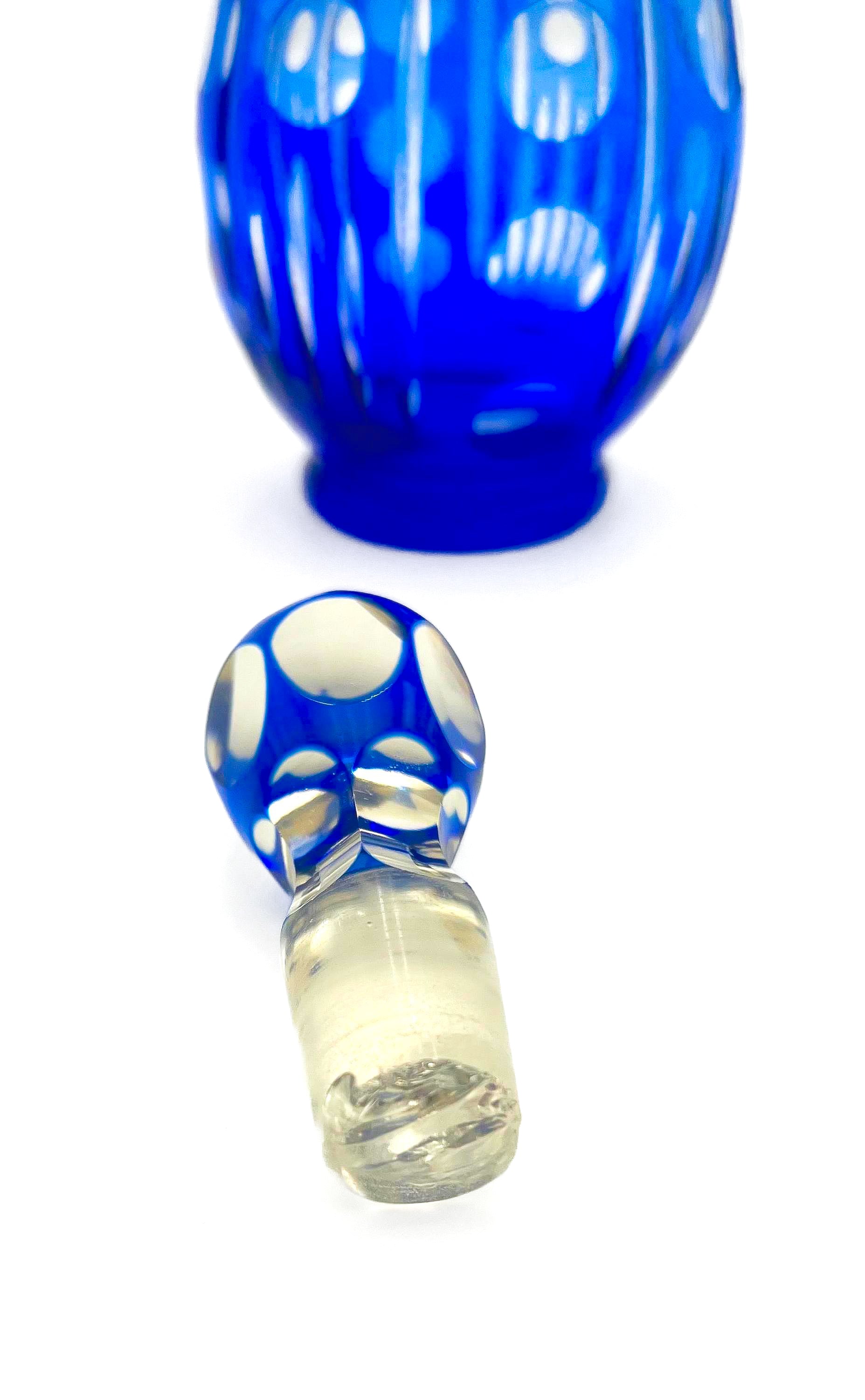 Minimalist mid-century modern decanter in a deep cobalt blue glass with a matching round stopper.