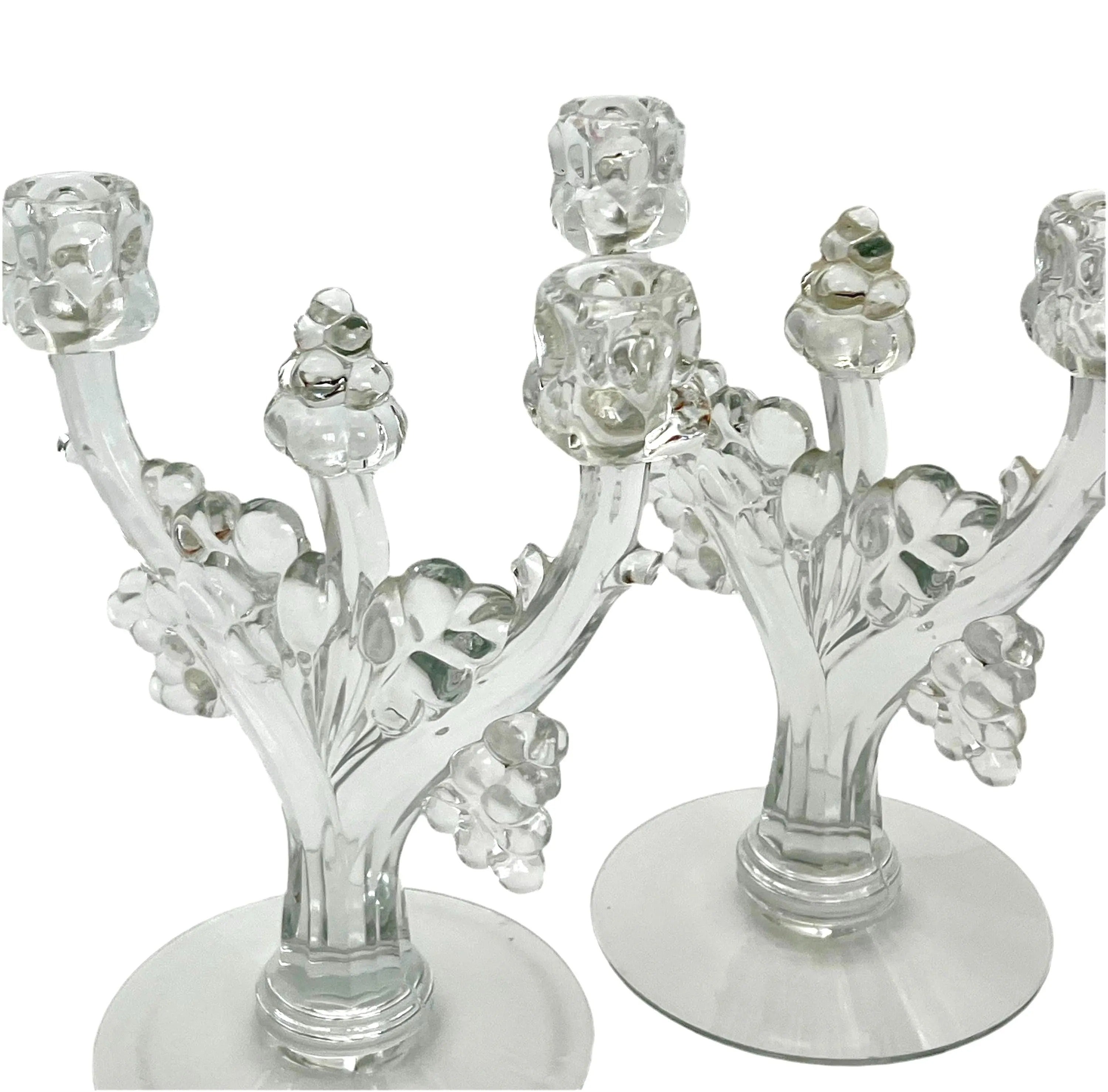Pair of 1930s Heisey glass candelabras featuring rare molded grape cluster designs and elegant glass arms.