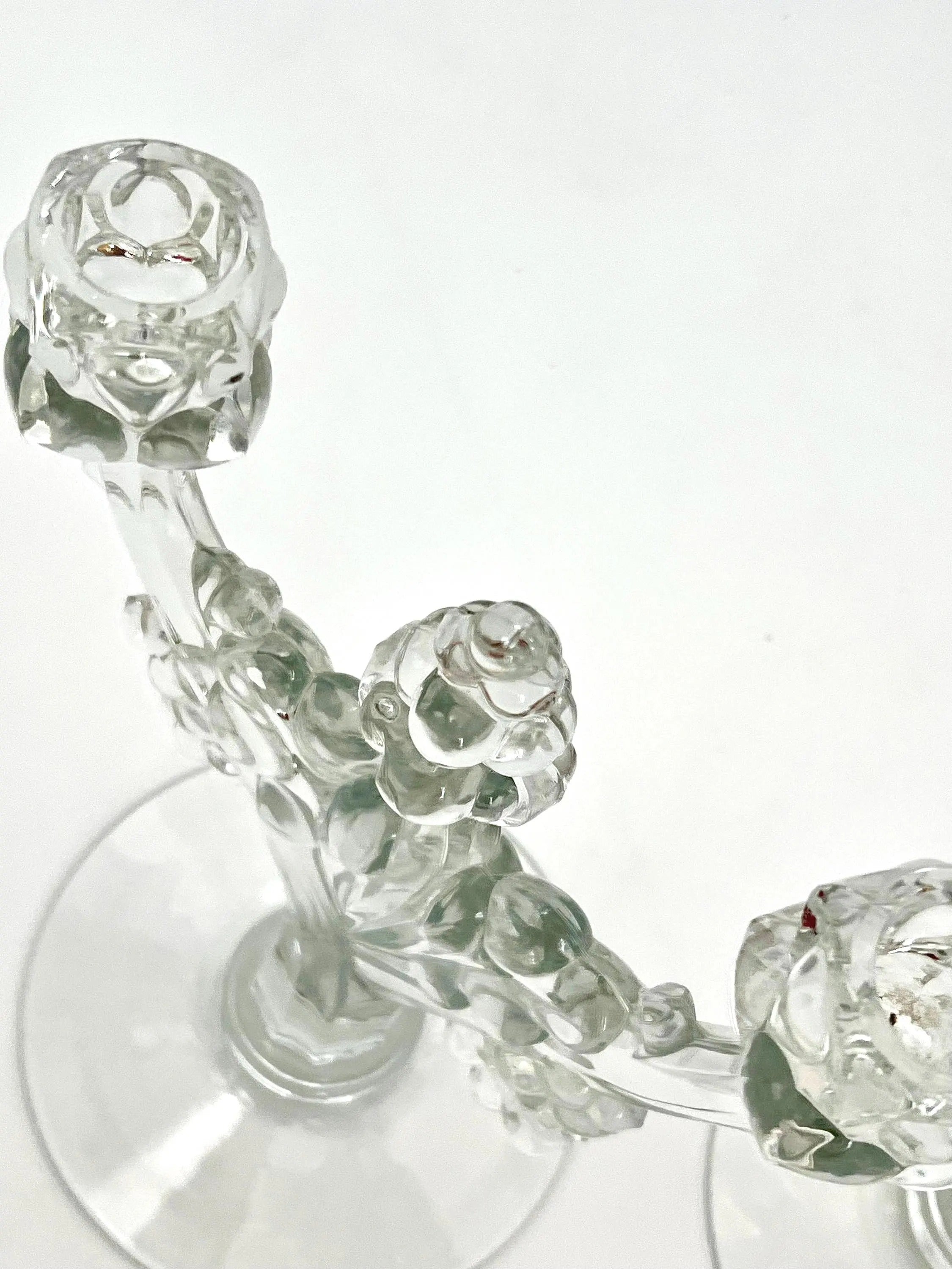 Pair of 1930s Heisey glass candelabras featuring rare molded grape cluster designs and elegant glass arms.