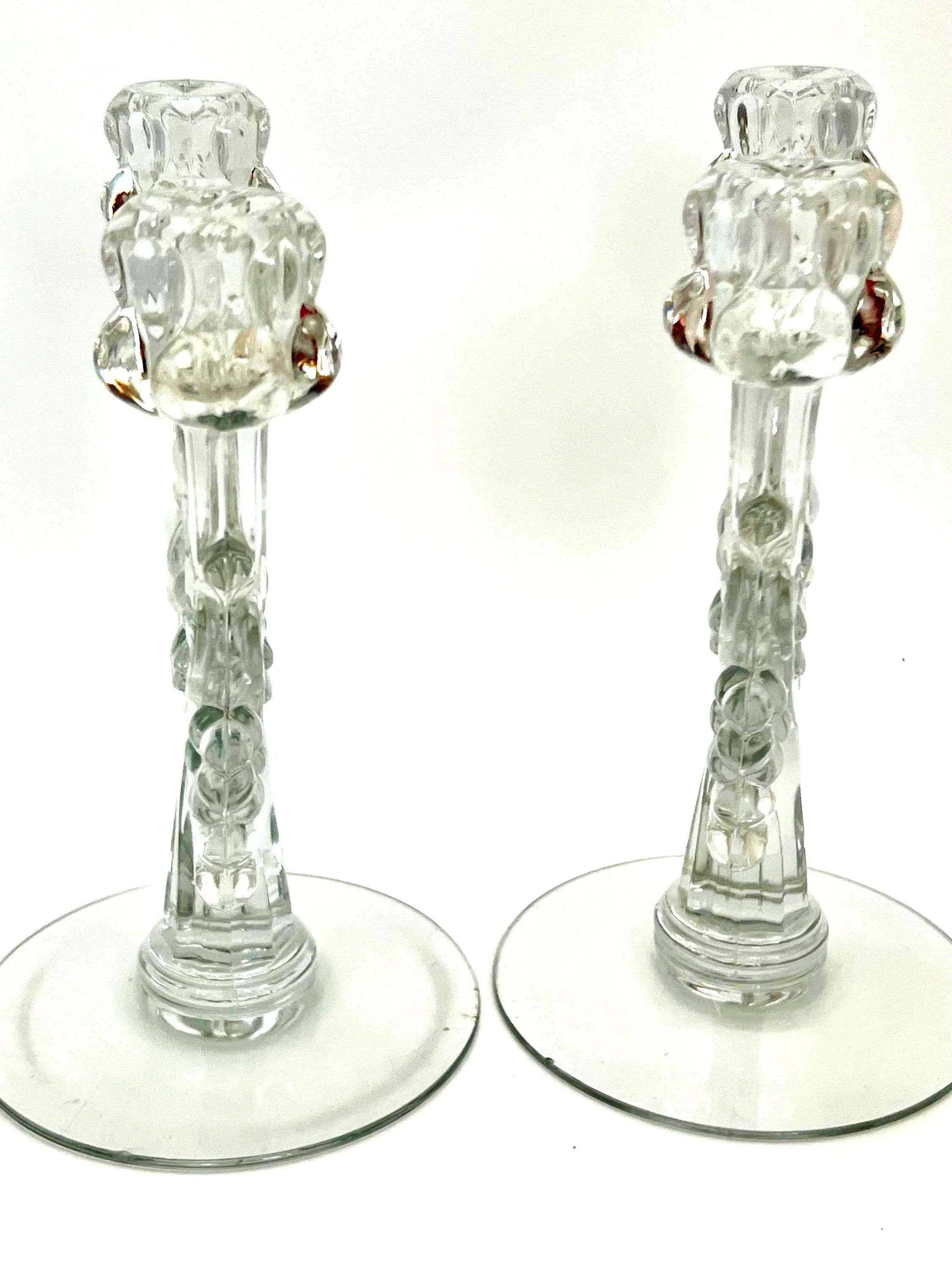 Pair of 1930s Heisey glass candelabras featuring rare molded grape cluster designs and elegant glass arms.