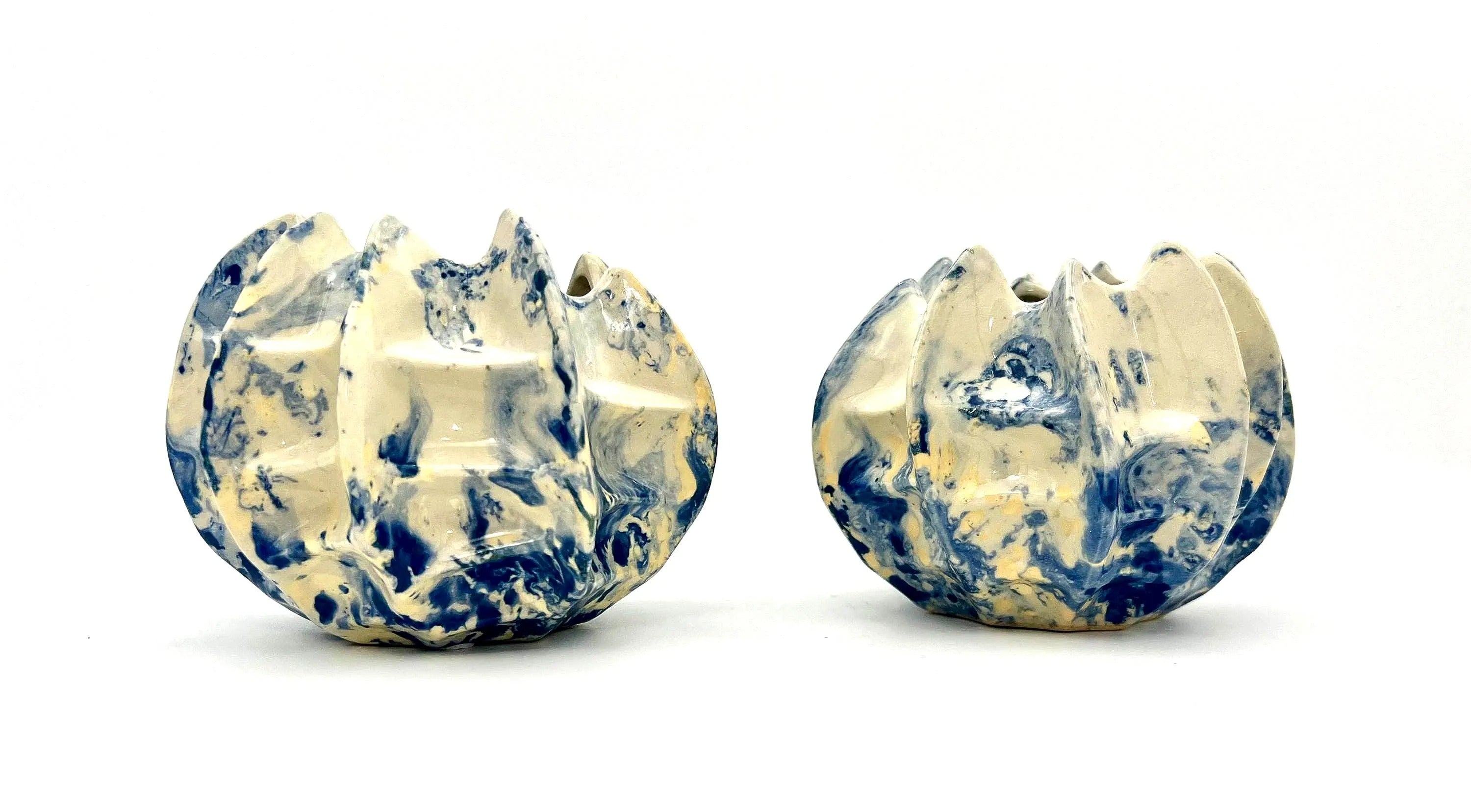 Pair of vintage ceramic planters or candle holders with an abstract blue and white splatter-ware pattern.