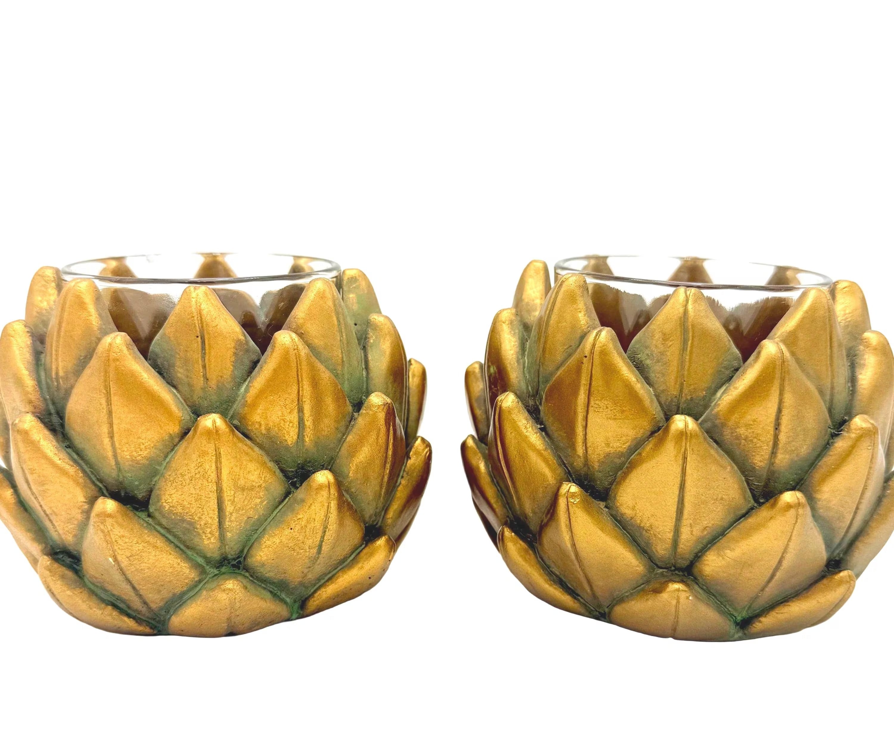 Pair of heavy vintage votive holders shaped like golden artichokes with a metallic finish.