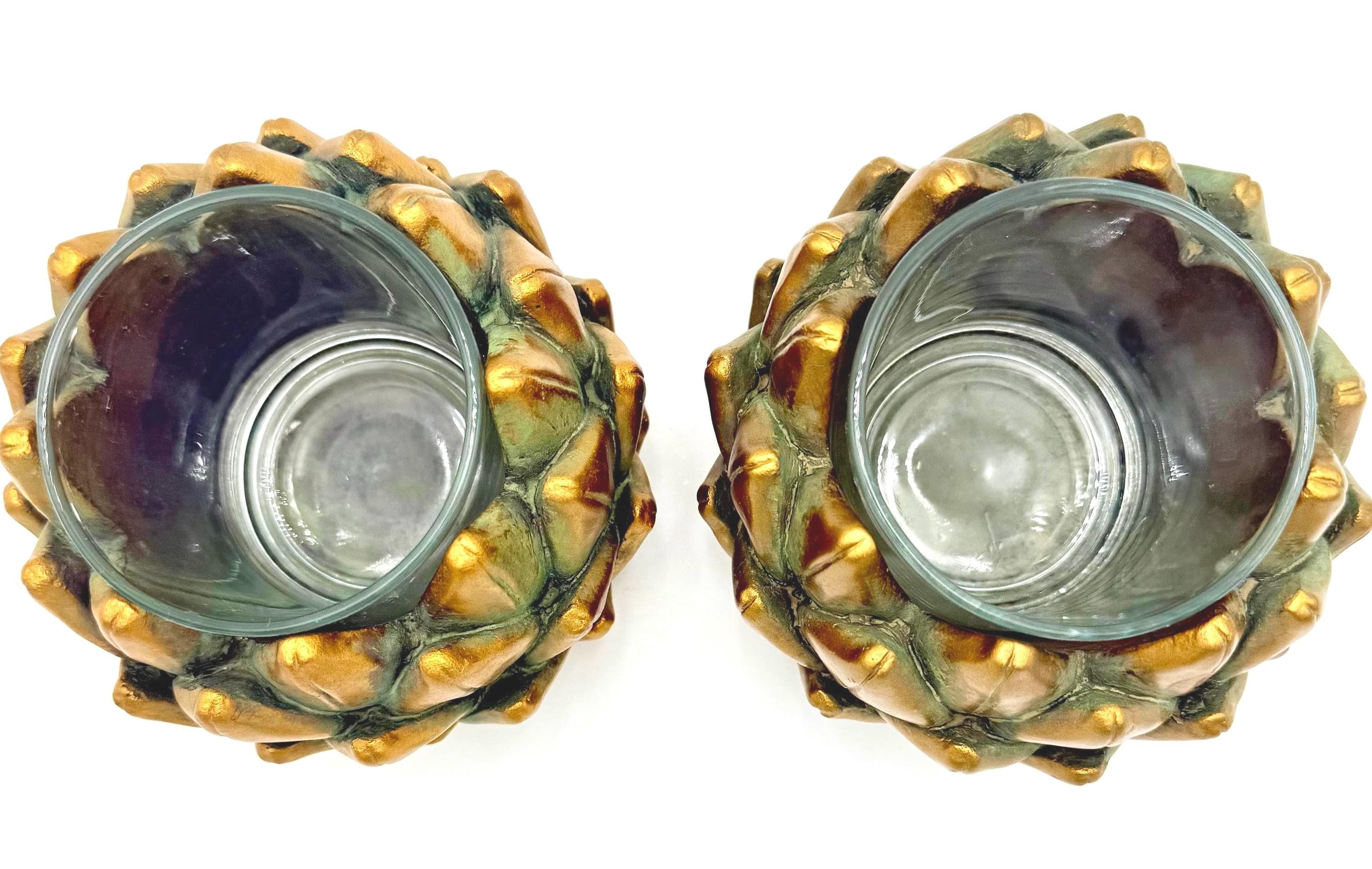 Pair of heavy vintage votive holders shaped like golden artichokes with a metallic finish.