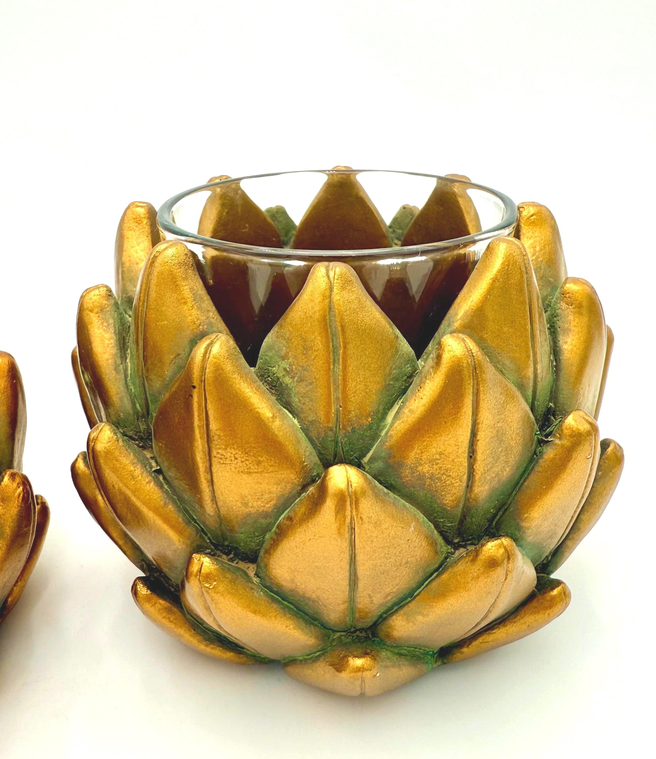 Pair of heavy vintage votive holders shaped like golden artichokes with a metallic finish.