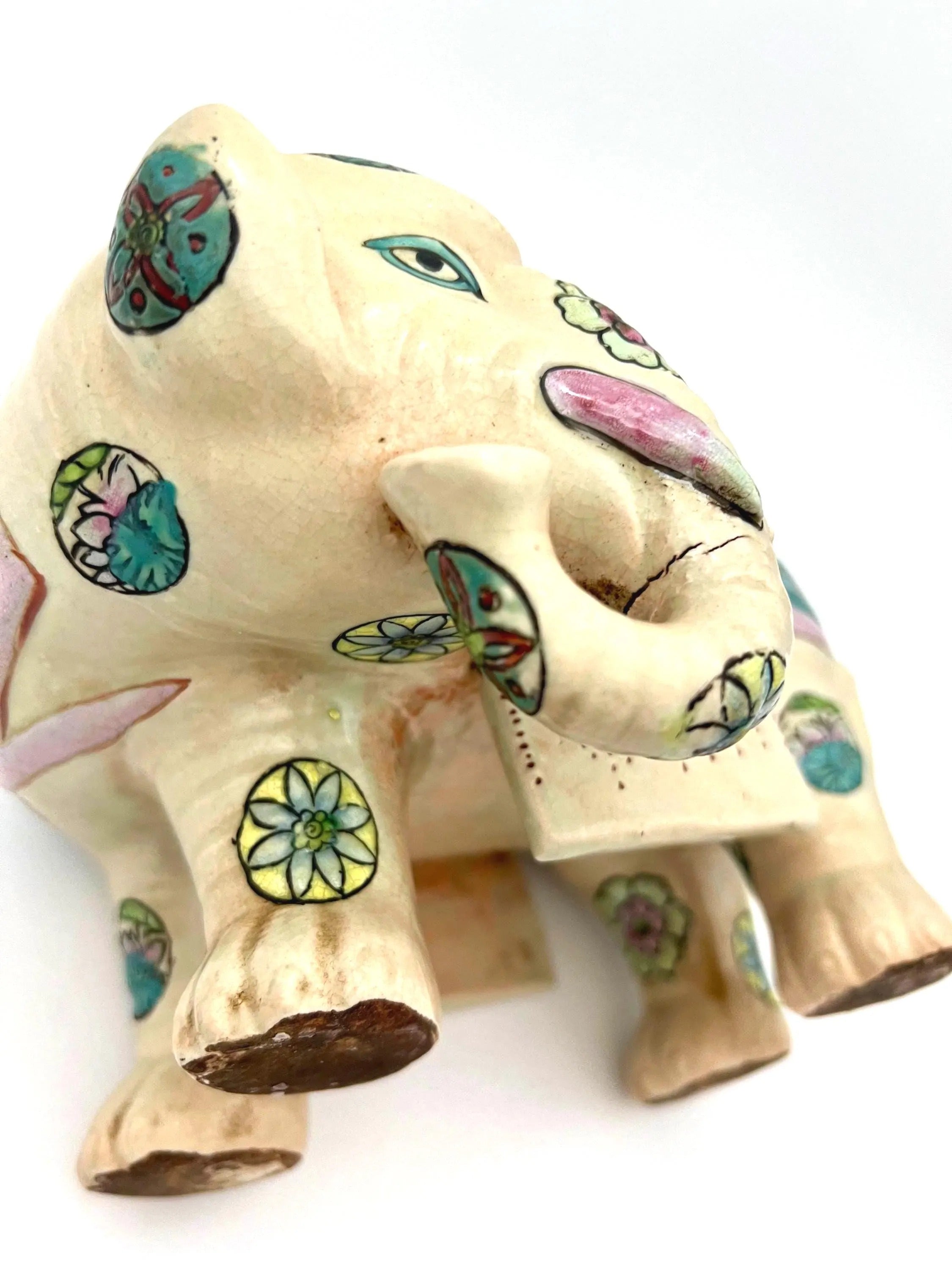 Hand-painted antique Chinese porcelain elephant candleholder with an ornate saddle and floral motifs.