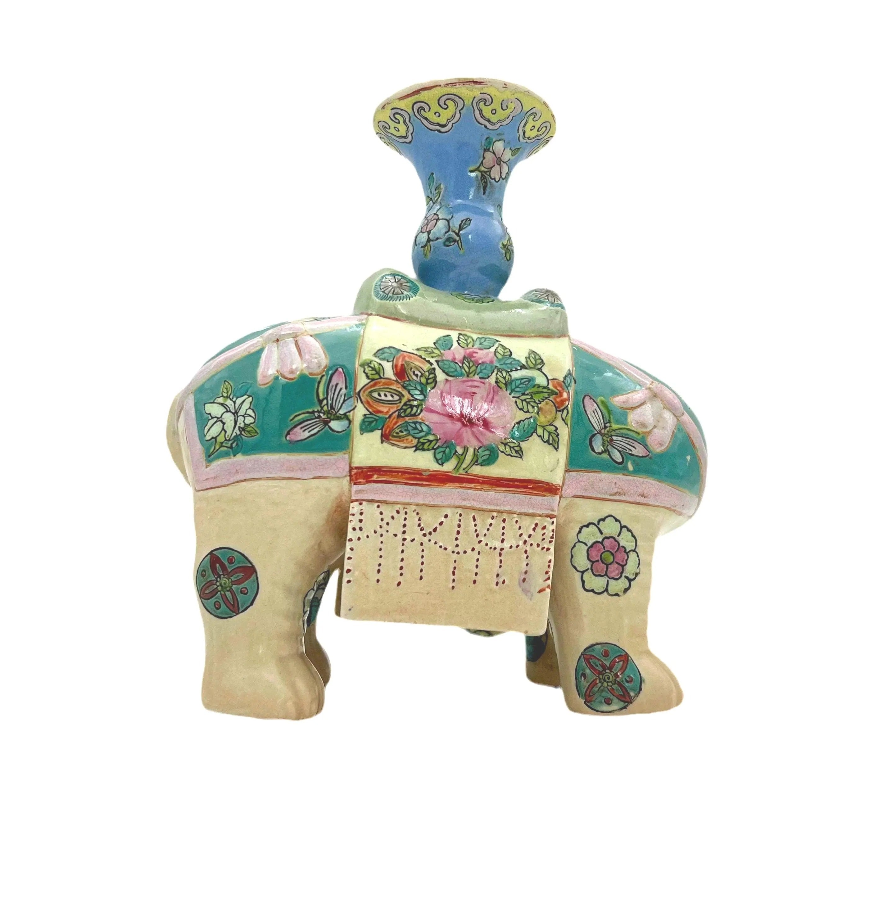 Hand-painted antique Chinese porcelain elephant candleholder with an ornate saddle and floral motifs.