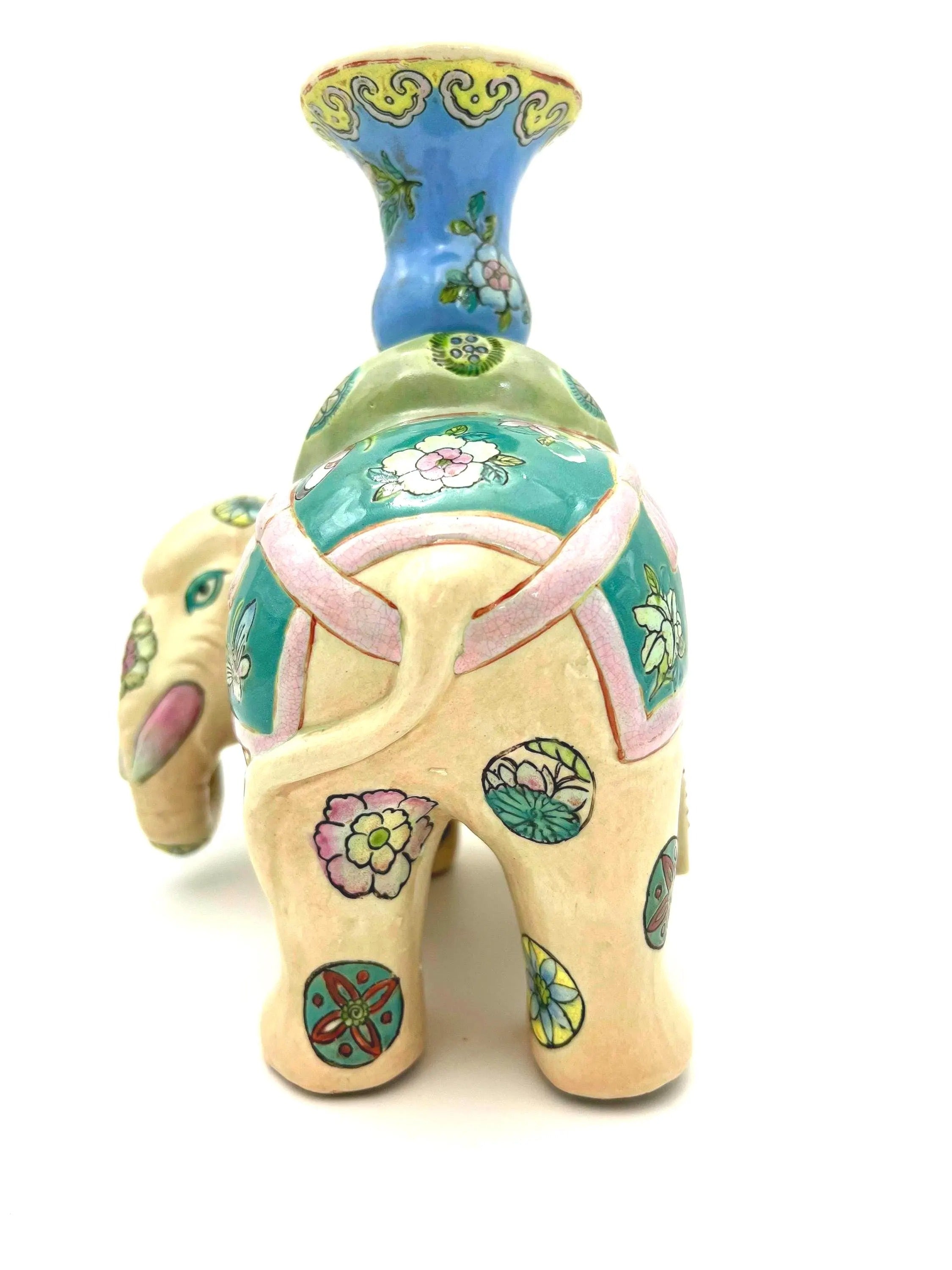 Hand-painted antique Chinese porcelain elephant candleholder with an ornate saddle and floral motifs.