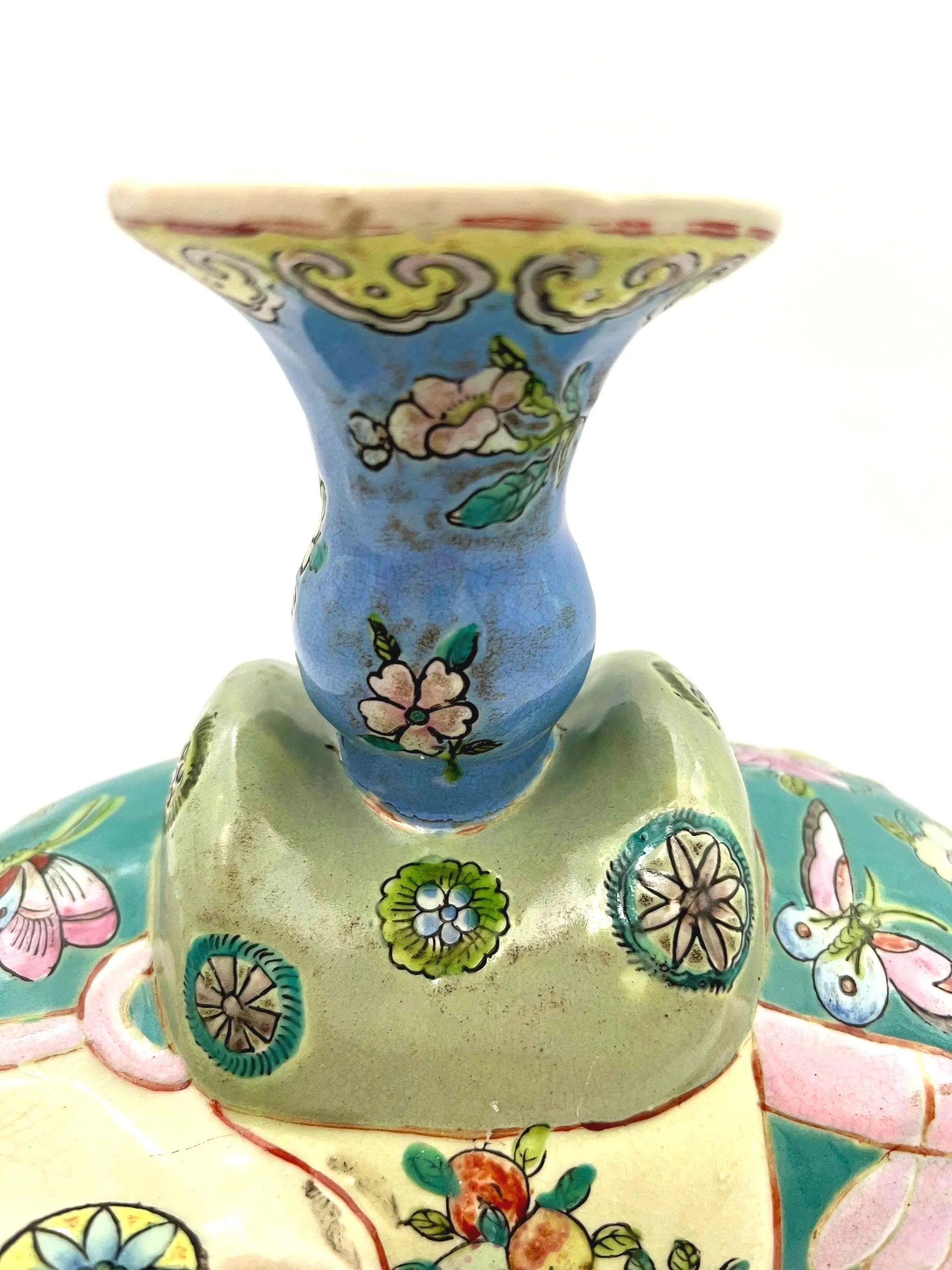 Hand-painted antique Chinese porcelain elephant candleholder with an ornate saddle and floral motifs.