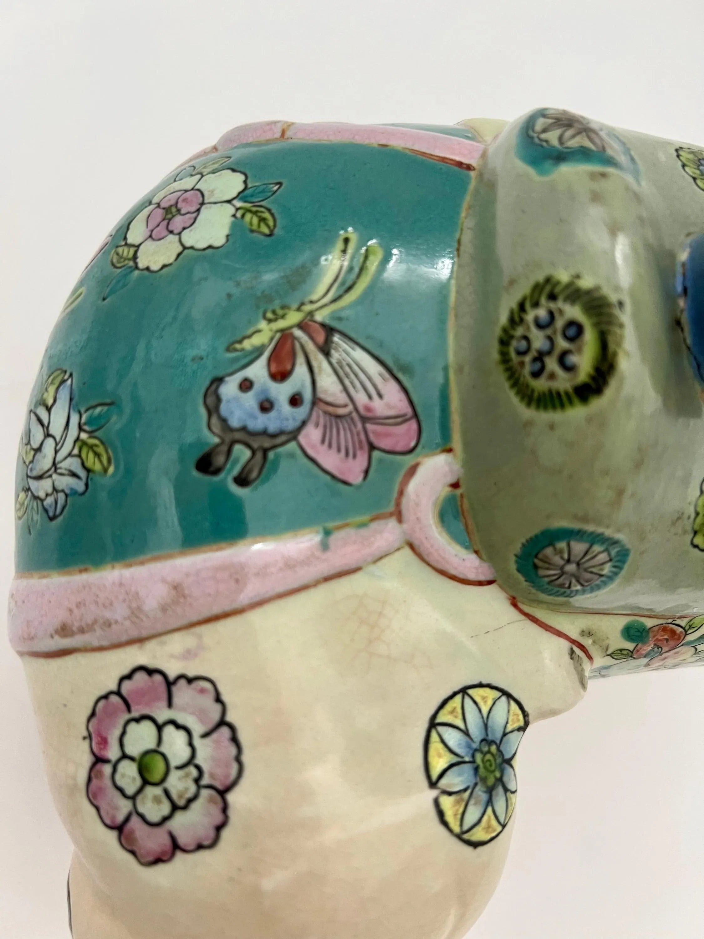 Hand-painted antique Chinese porcelain elephant candleholder with an ornate saddle and floral motifs.