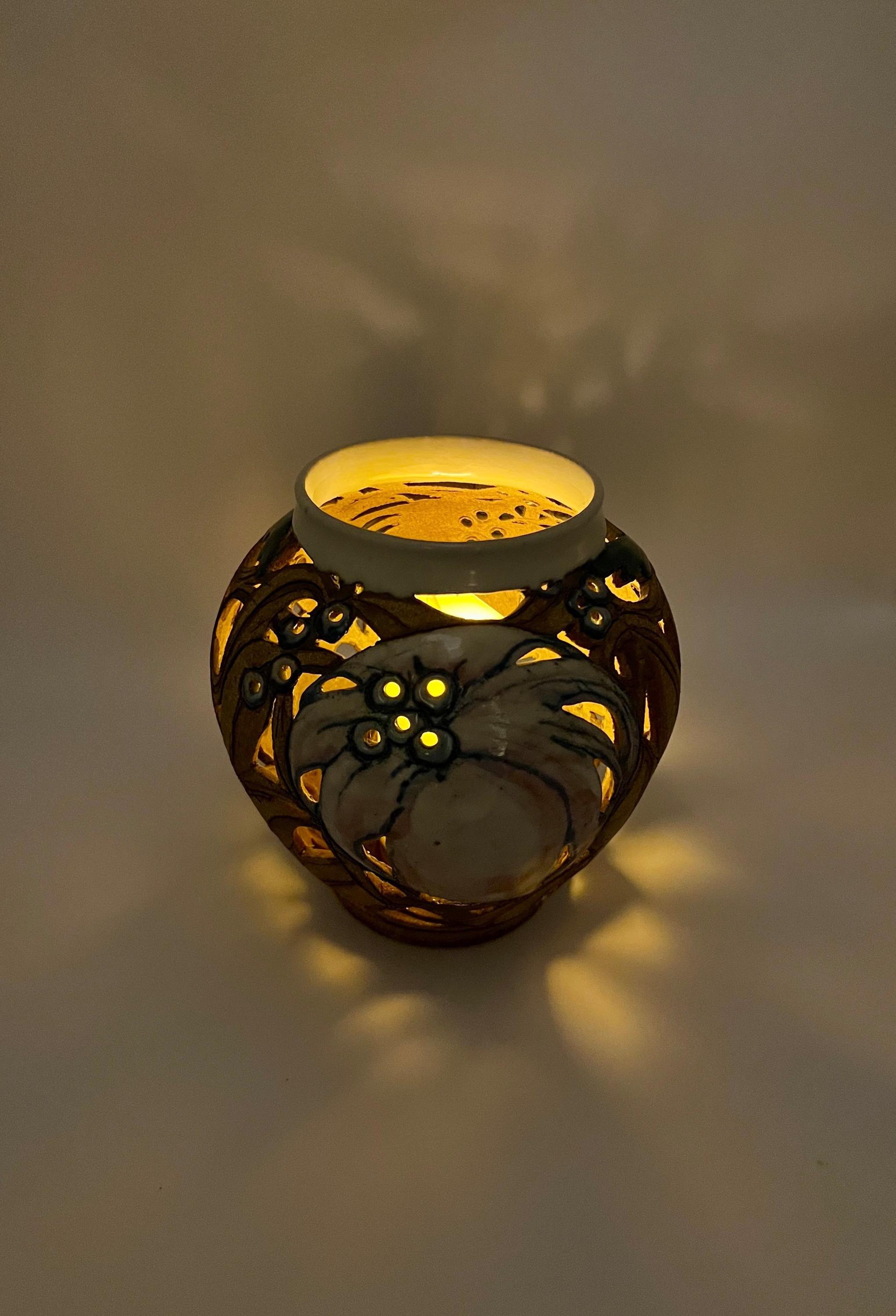 Artist-signed decorative piece featuring a hummingbird motif, usable as a vase or candle lantern.