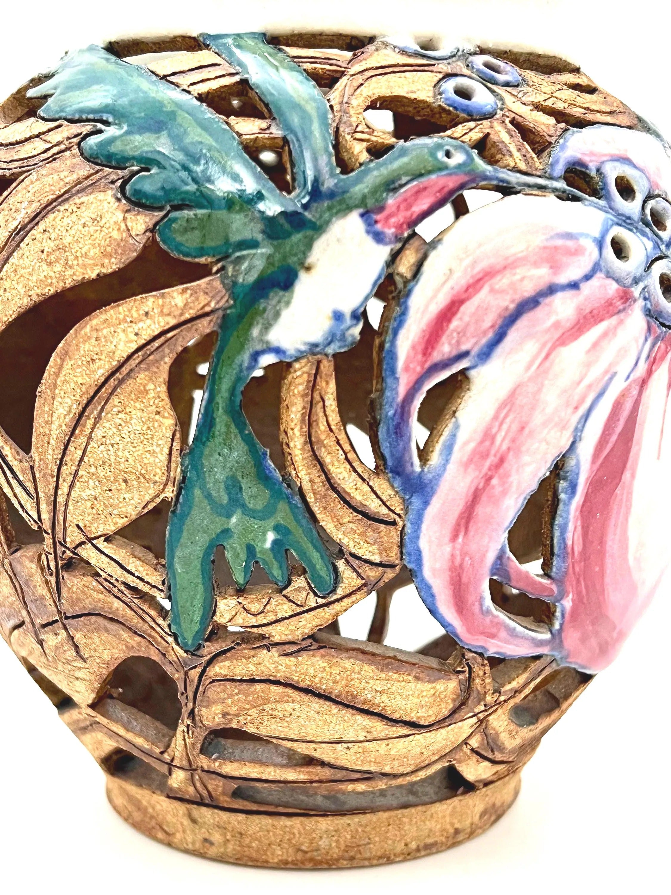 Artist-signed decorative piece featuring a hummingbird motif, usable as a vase or candle lantern.