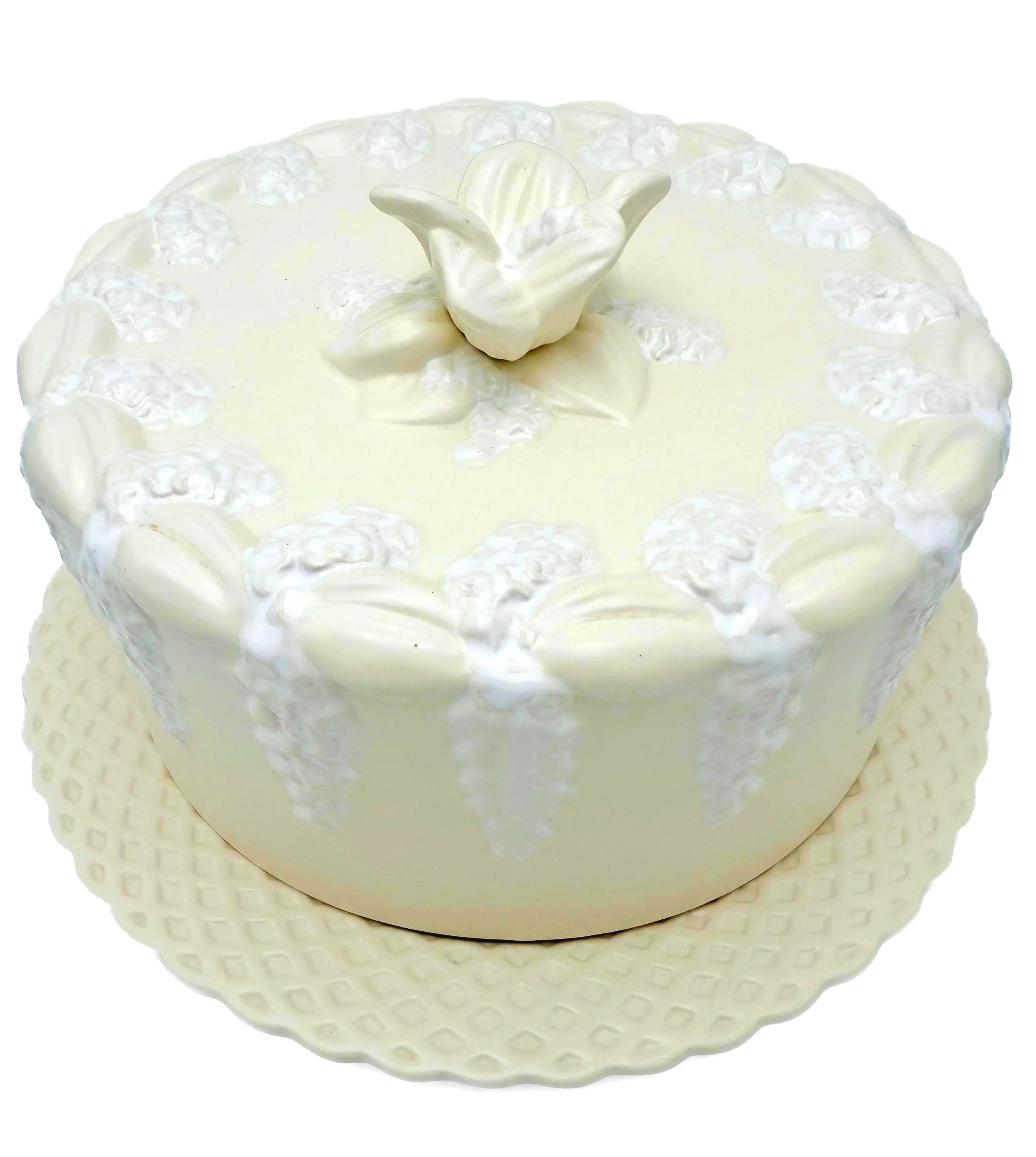 Large Portuguese earthenware dome and matching plate with a cream-white floral relief design.