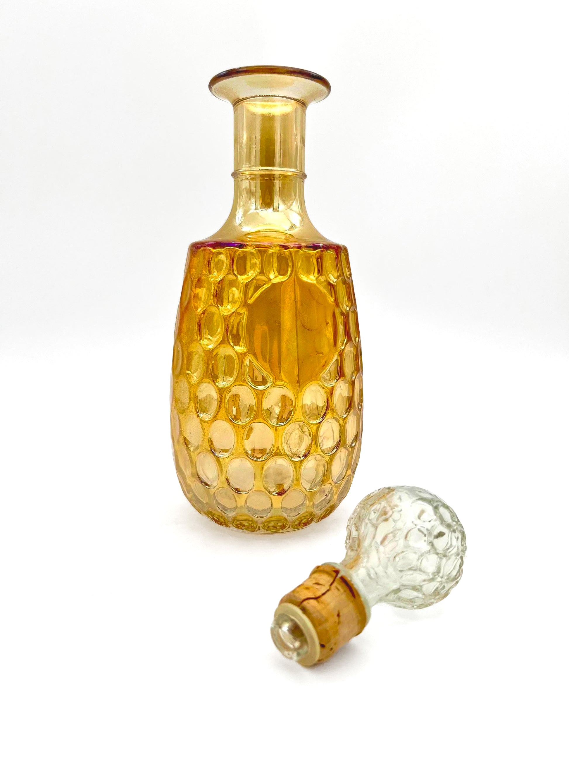 Vintage 1960s Old Forester whisky decanter in iridescent carnival glass with a textured geometric pattern.