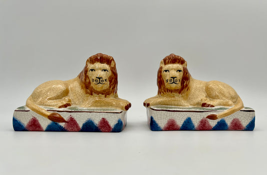 AUTHENTIC PAIR OF ANTIQUE STAFFORDSHIRE RECUMBENT LION FIGURINES, CIRCA 1800s