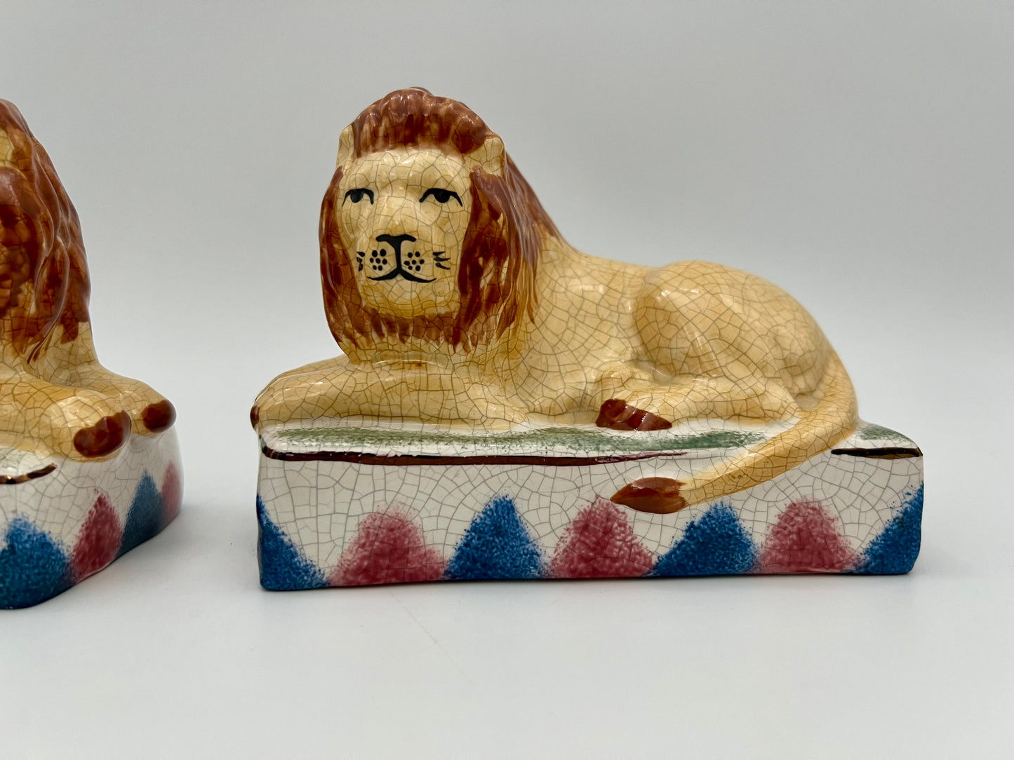 AUTHENTIC PAIR OF ANTIQUE STAFFORDSHIRE RECUMBENT LION FIGURINES, CIRCA 1800s