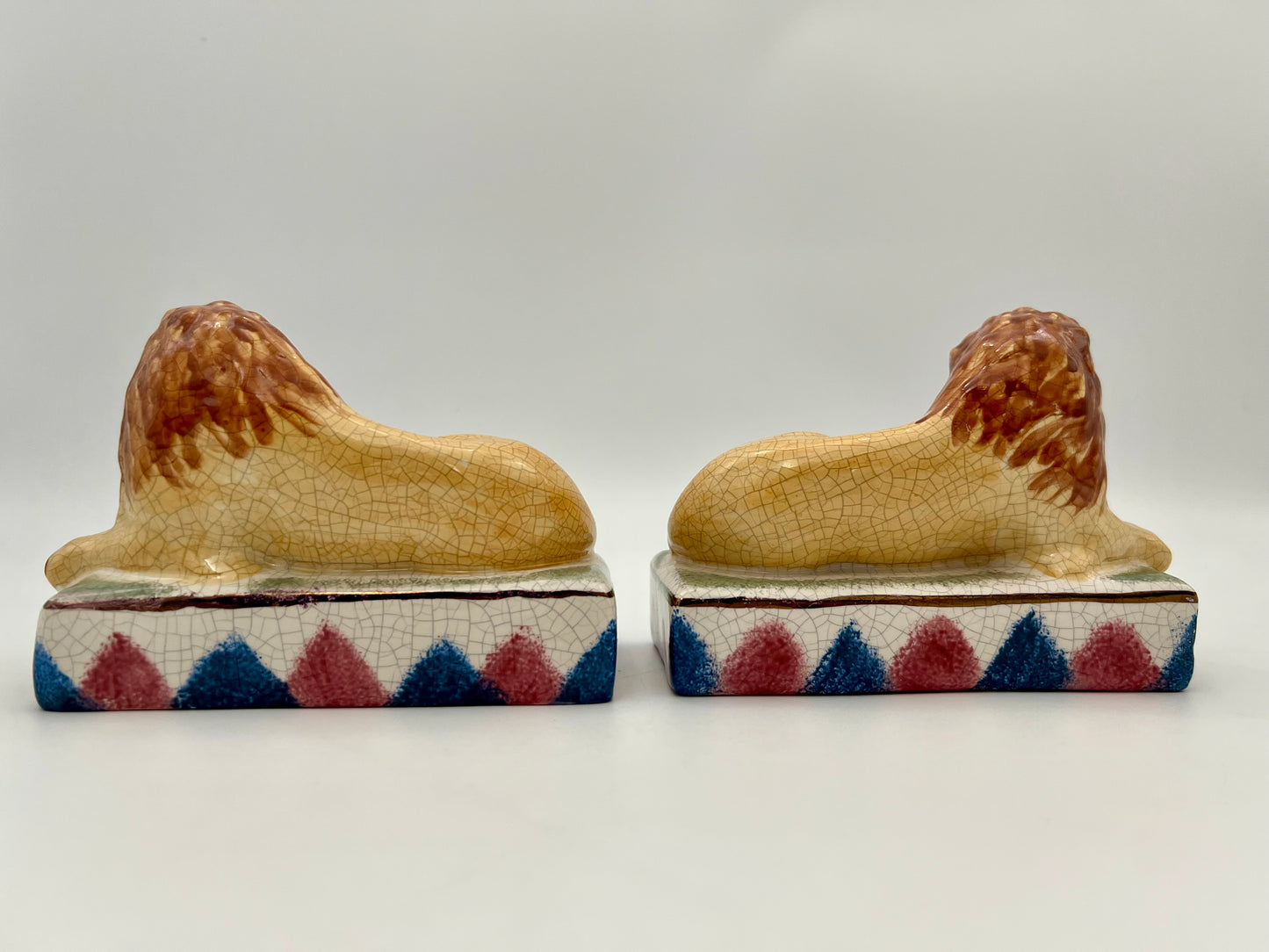 AUTHENTIC PAIR OF ANTIQUE STAFFORDSHIRE RECUMBENT LION FIGURINES, CIRCA 1800s
