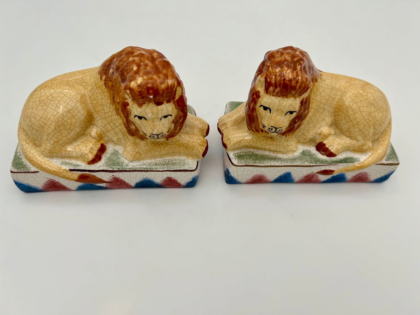 AUTHENTIC PAIR OF ANTIQUE STAFFORDSHIRE RECUMBENT LION FIGURINES, CIRCA 1800s
