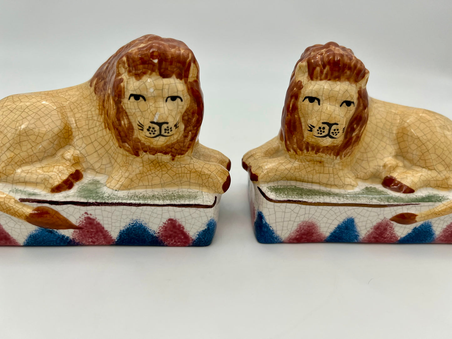 AUTHENTIC PAIR OF ANTIQUE STAFFORDSHIRE RECUMBENT LION FIGURINES, CIRCA 1800s