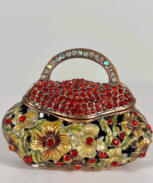 VINTAGE SMALL TRINKET/JEWELRY BOX PURSE SHAPED WITH CUT OUT FLOWERS AND RED CRYSTALS