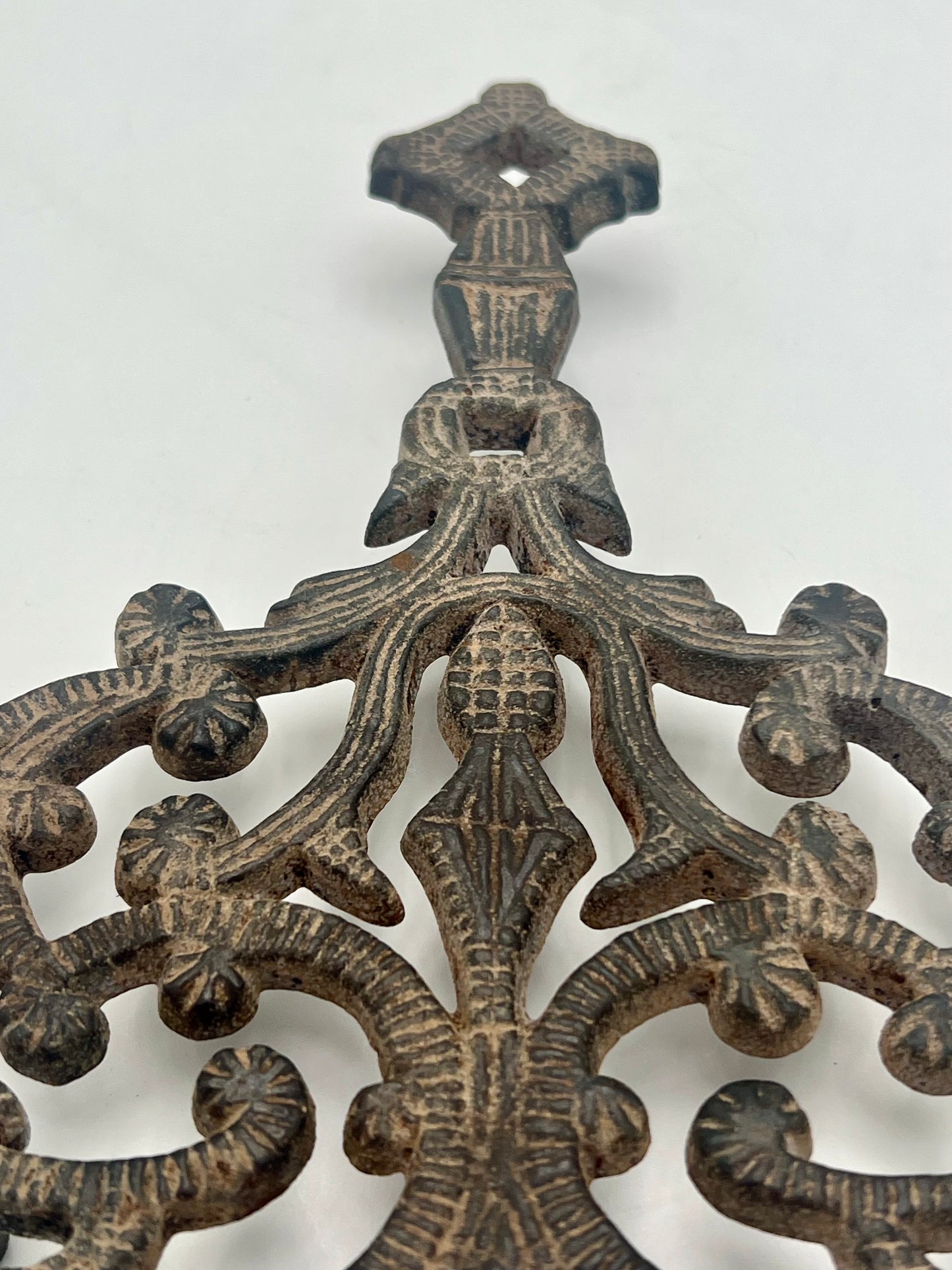 ANTIQUE J.Z.H. CAST IRON TRIVET, CIRCA 1949