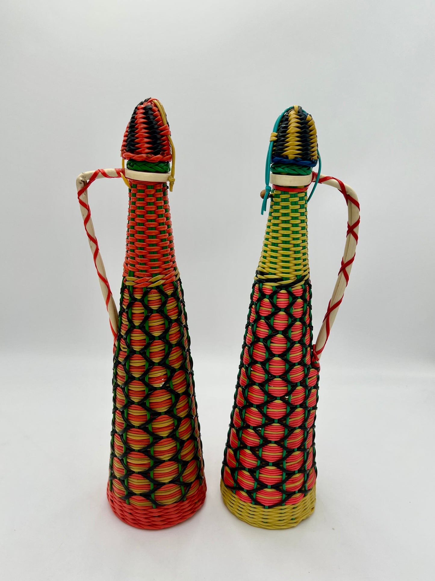 PAIR OF 1960s BOHO SCOUBIDOU WOVEN PLASTIC GLASS BOTTLE DECANTER, SPAIN