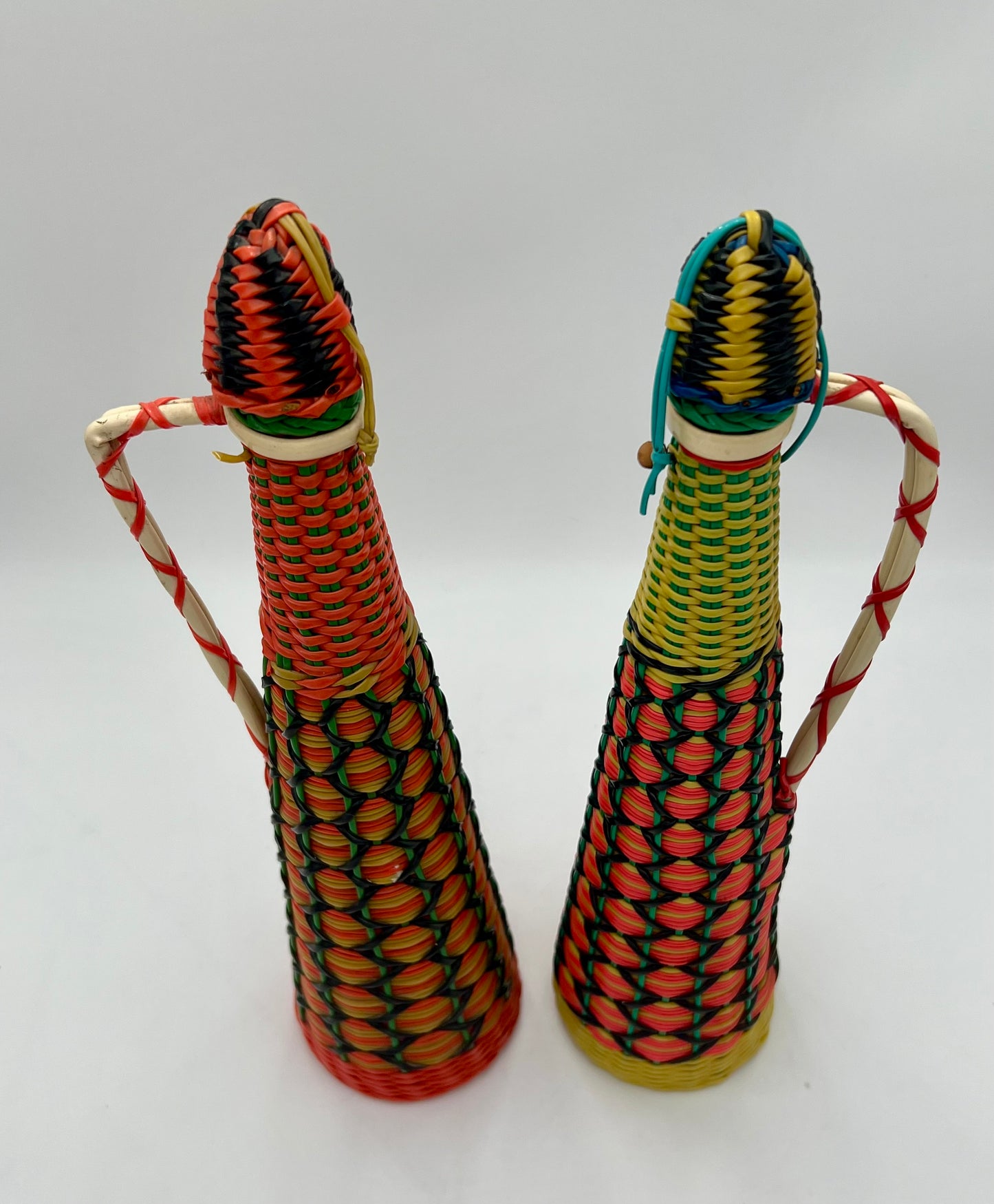 PAIR OF 1960s BOHO SCOUBIDOU WOVEN PLASTIC GLASS BOTTLE DECANTER, SPAIN