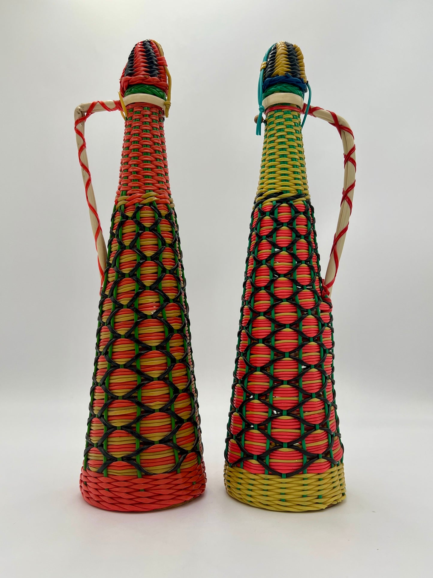 PAIR OF 1960s BOHO SCOUBIDOU WOVEN PLASTIC GLASS BOTTLE DECANTER, SPAIN