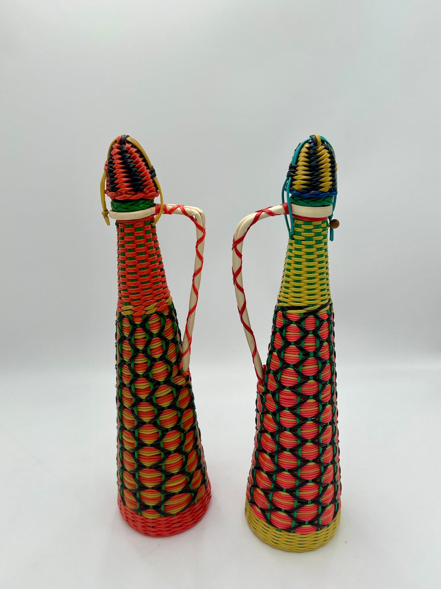 PAIR OF 1960s BOHO SCOUBIDOU WOVEN PLASTIC GLASS BOTTLE DECANTER, SPAIN