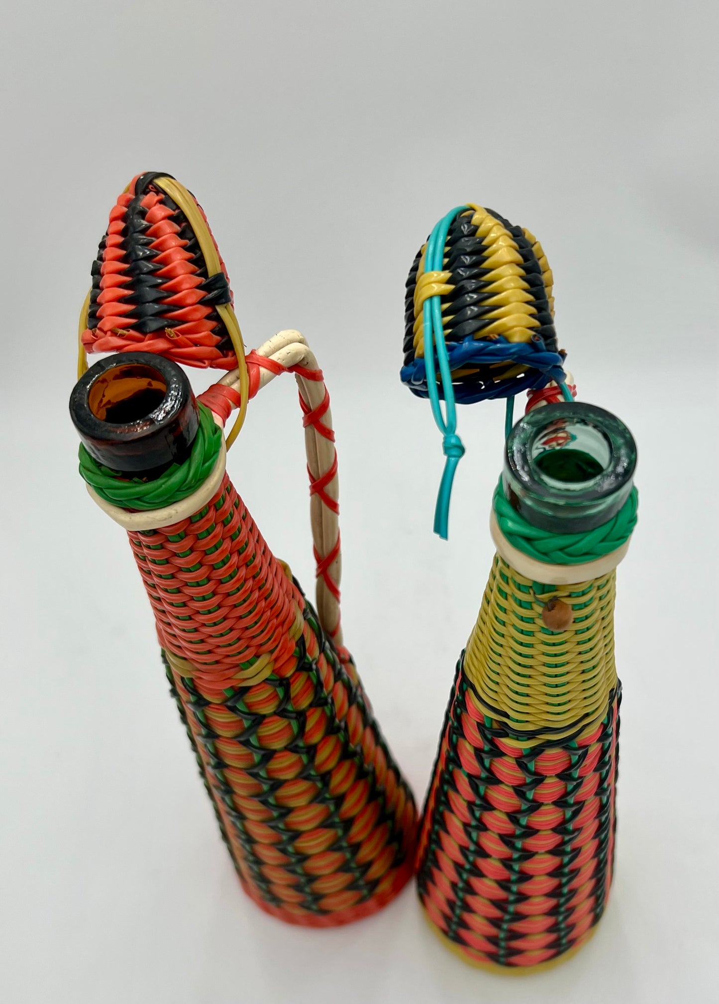 PAIR OF 1960s BOHO SCOUBIDOU WOVEN PLASTIC GLASS BOTTLE DECANTER, SPAIN