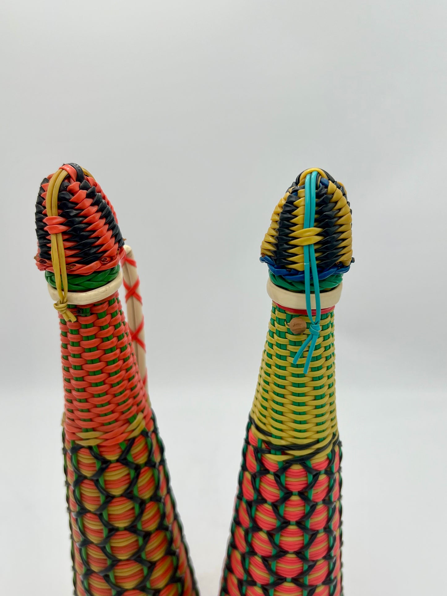 PAIR OF 1960s BOHO SCOUBIDOU WOVEN PLASTIC GLASS BOTTLE DECANTER, SPAIN