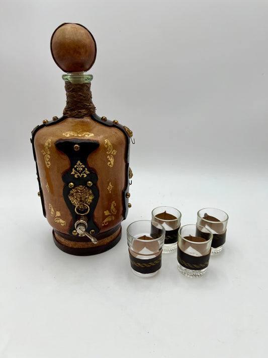 VINTAGE LEATHER WRAPPED WHISKY JUG WITH BRASS TAP AND4 LEATHER WRAPPED SHOT GLASSES