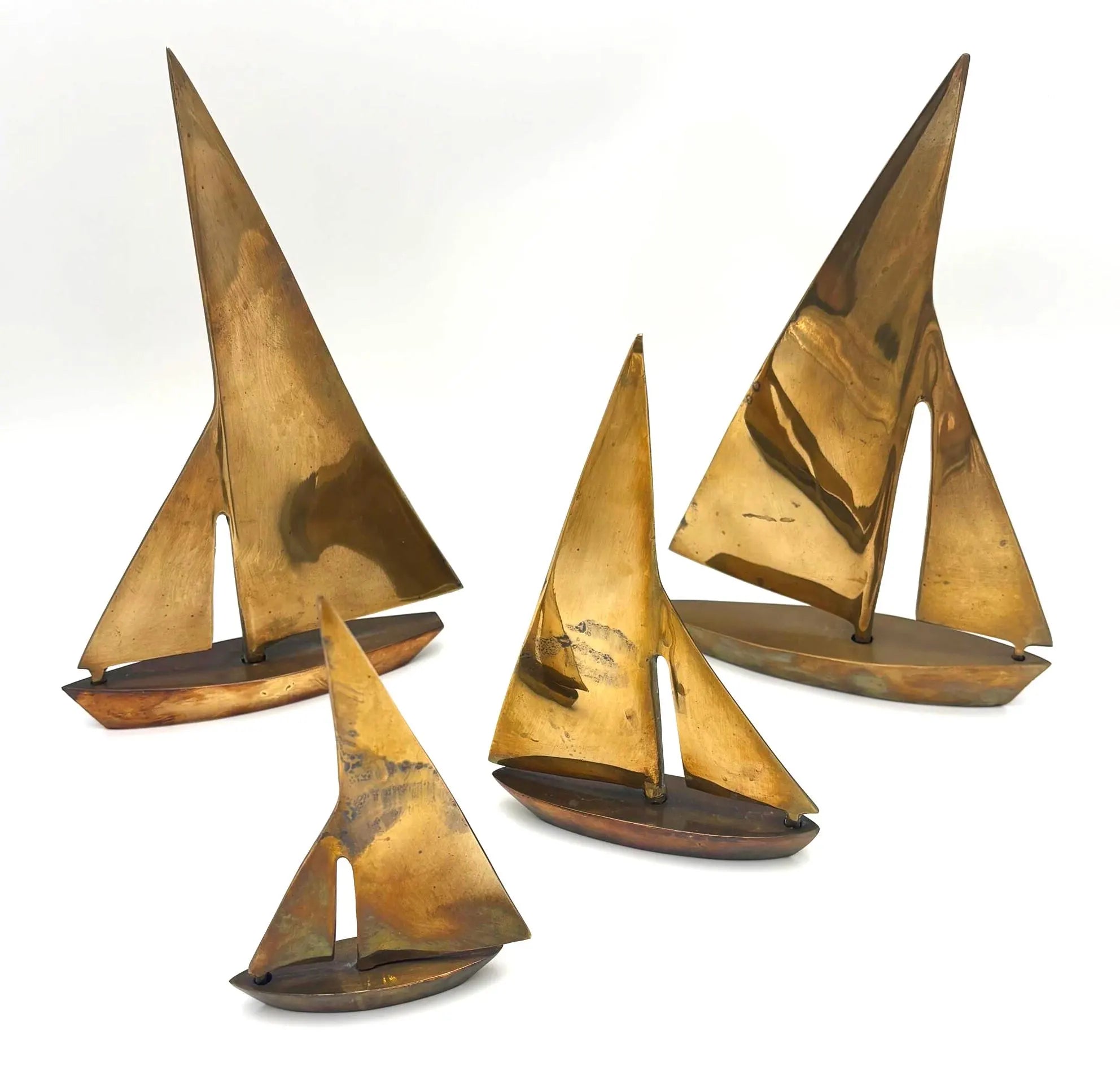 VINTAGE SOLID BRASS SAILBOAT SCULPTURES – COLLECTION OF FOUR MODERNIST YACHTS