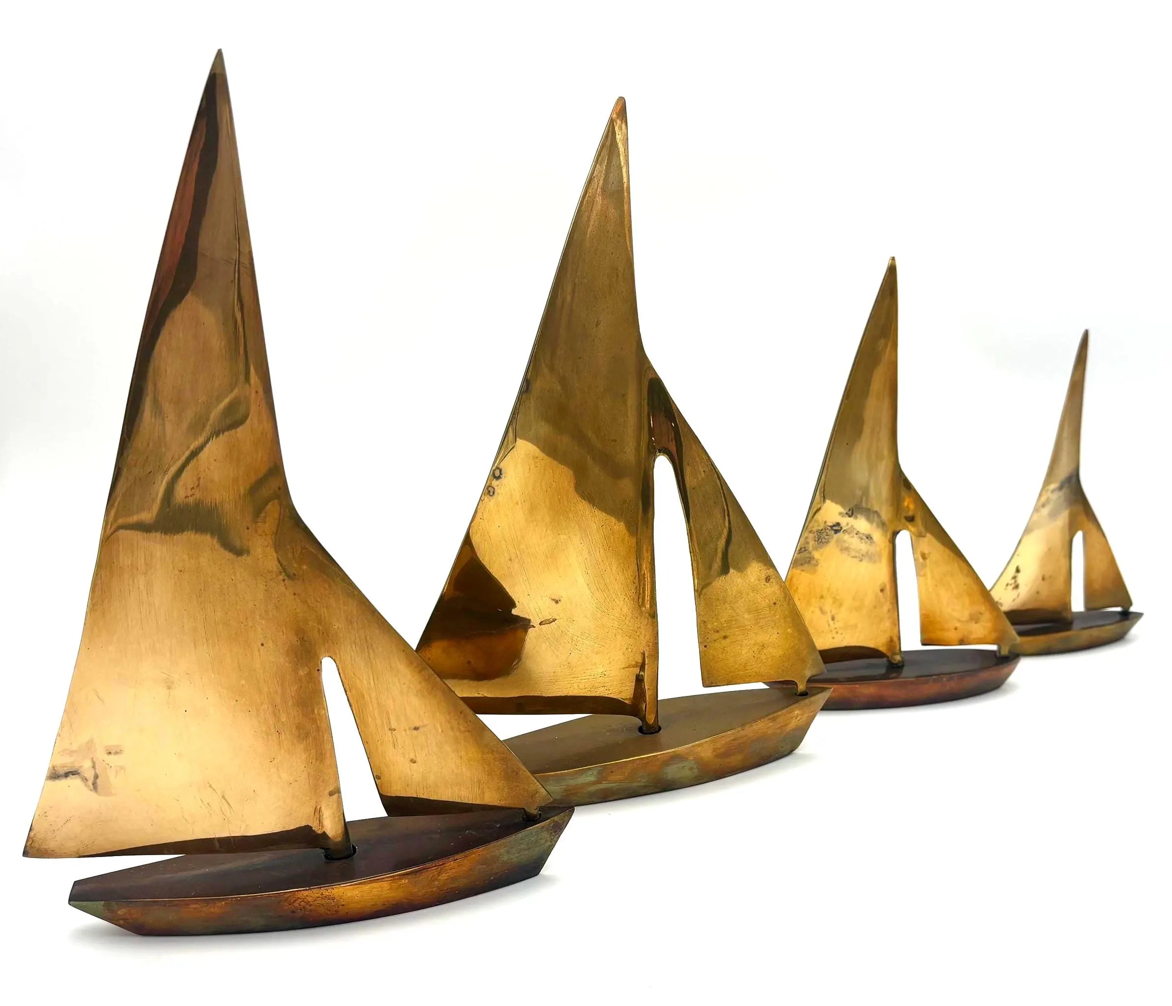 VINTAGE SOLID BRASS SAILBOAT SCULPTURES – COLLECTION OF FOUR MODERNIST YACHTS