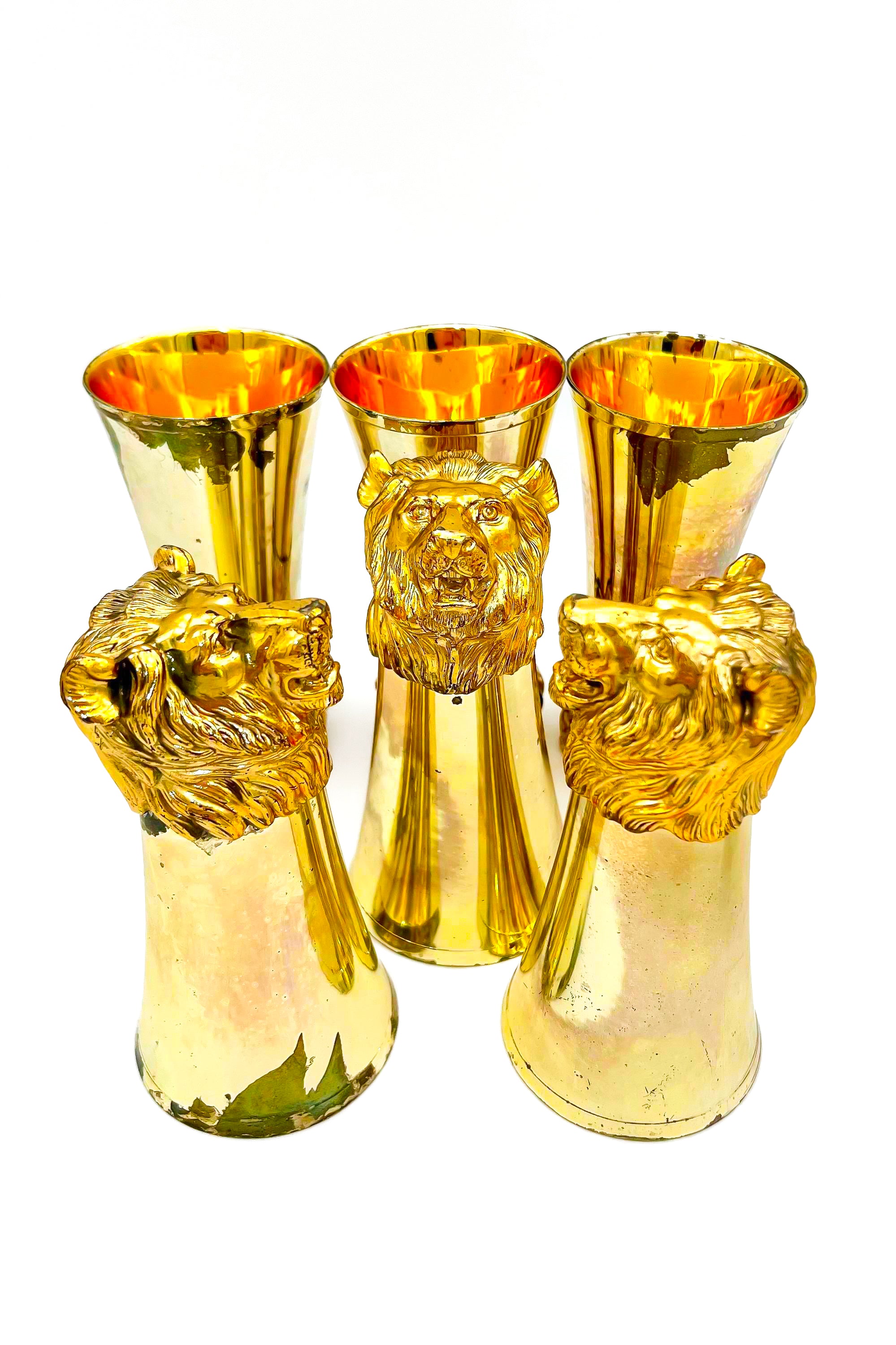 Rare set of 7 Carole Stupell mid-century barware featuring a glass pitcher and stirrup cups with silver-toned lion head bases.