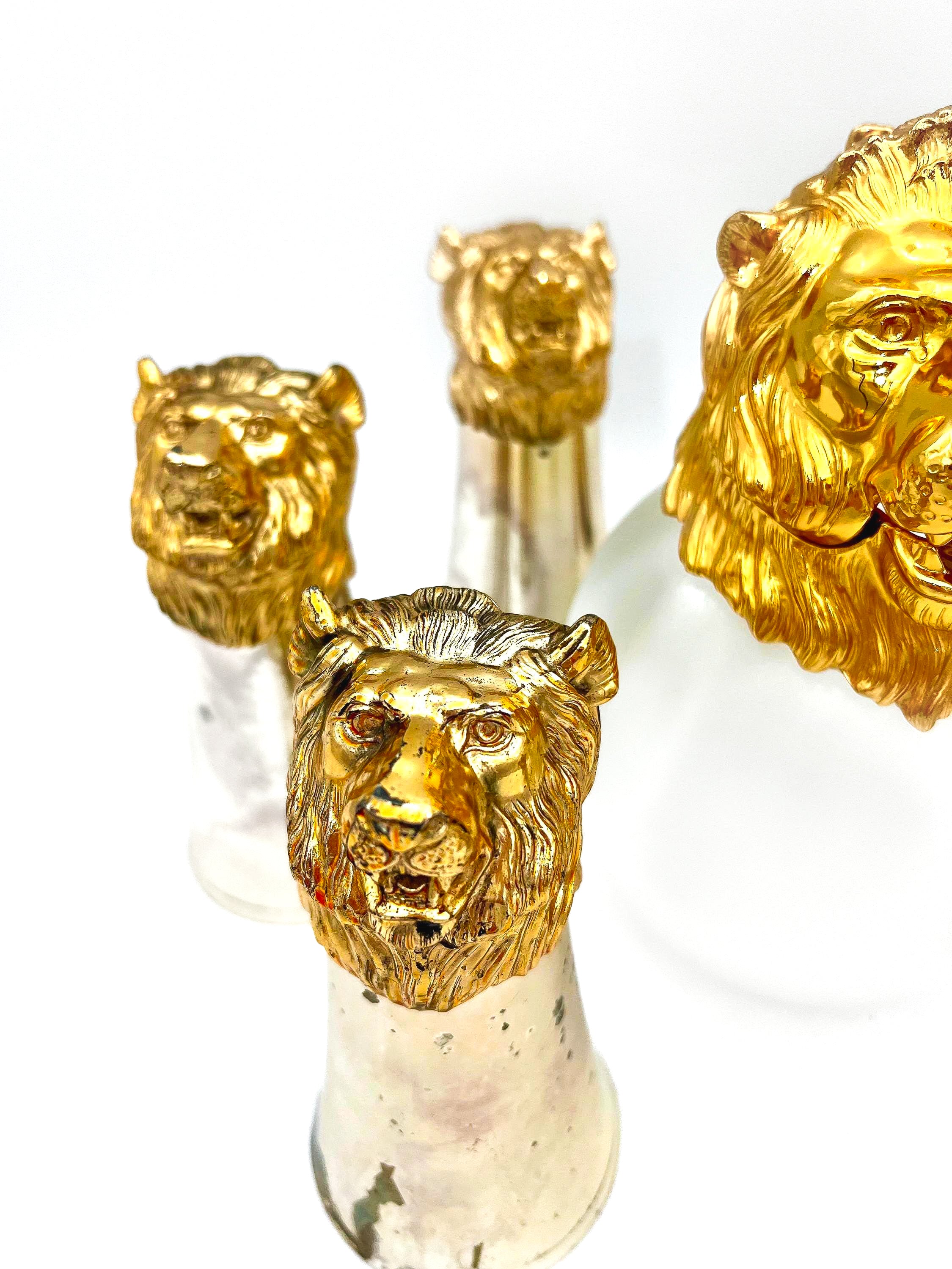 Rare set of 7 Carole Stupell mid-century barware featuring a glass pitcher and stirrup cups with silver-toned lion head bases.