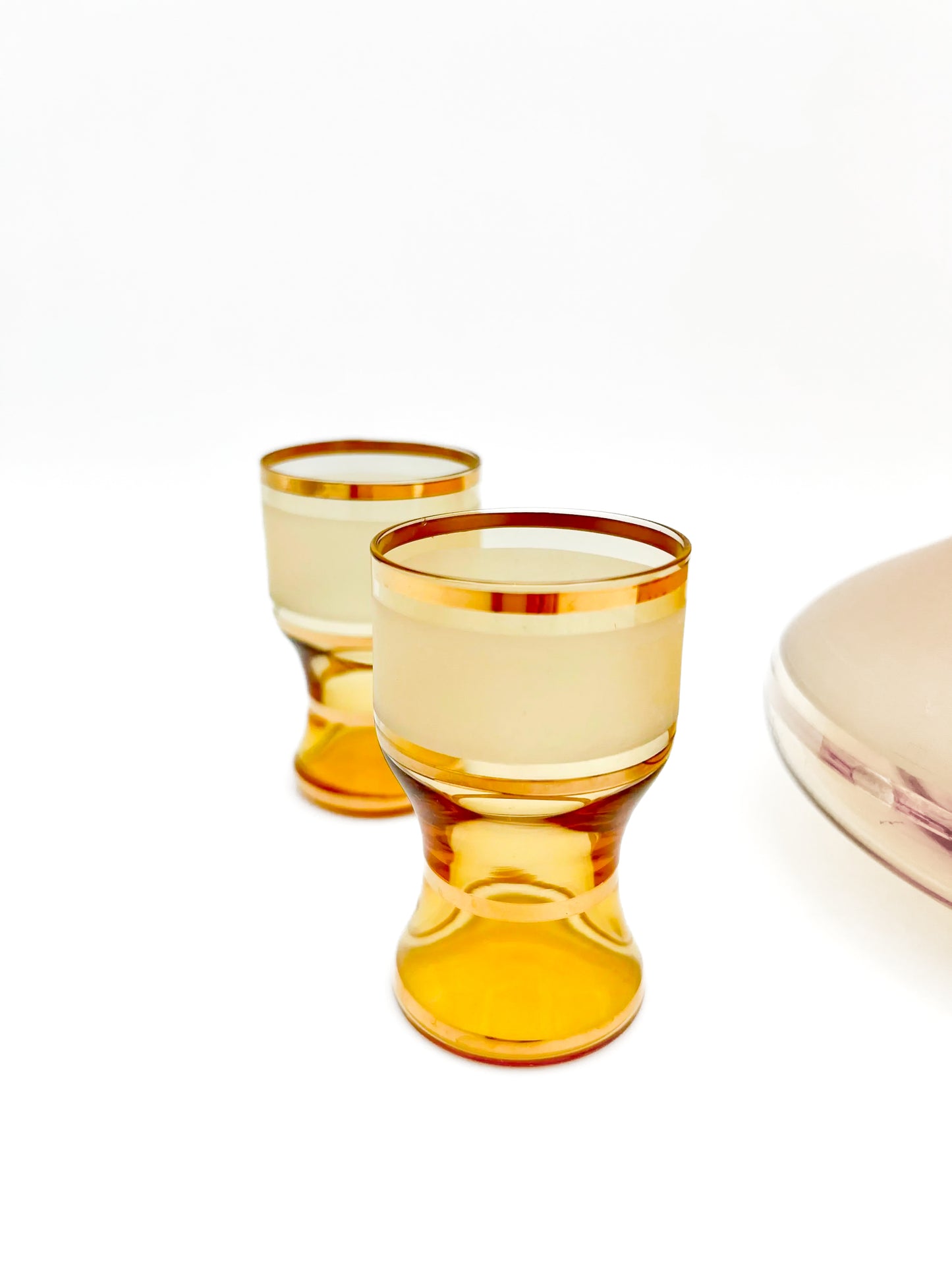 Vintage mid-century cordial set featuring an amber glass decanter with elegant gold filigree accents.