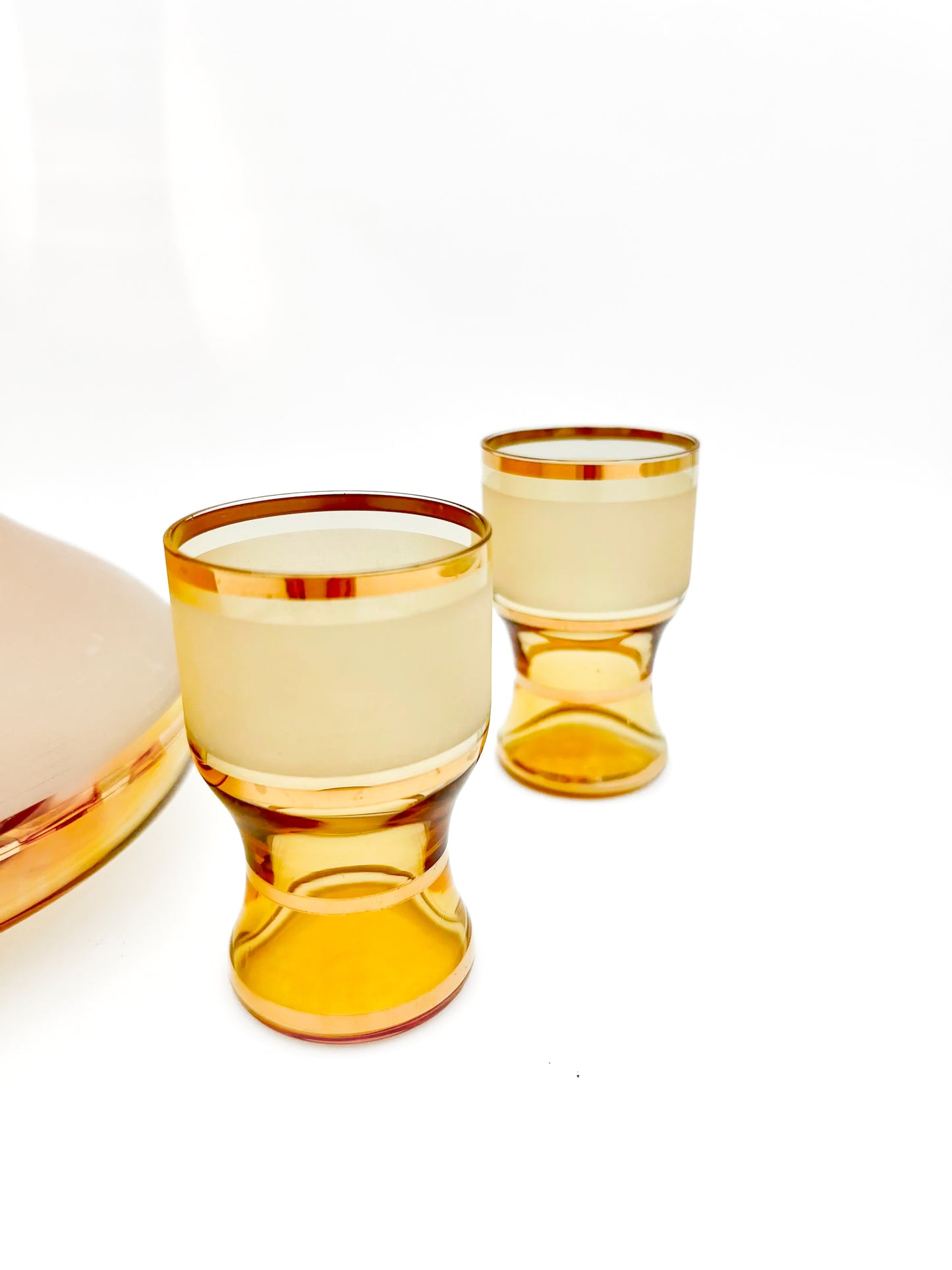 Vintage mid-century cordial set featuring an amber glass decanter with elegant gold filigree accents.