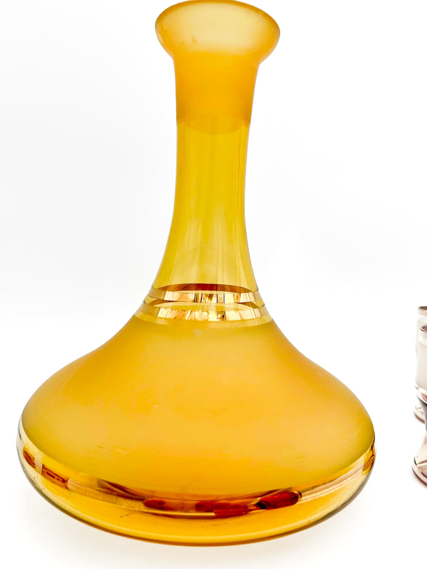 Vintage mid-century cordial set featuring an amber glass decanter with elegant gold filigree accents.
