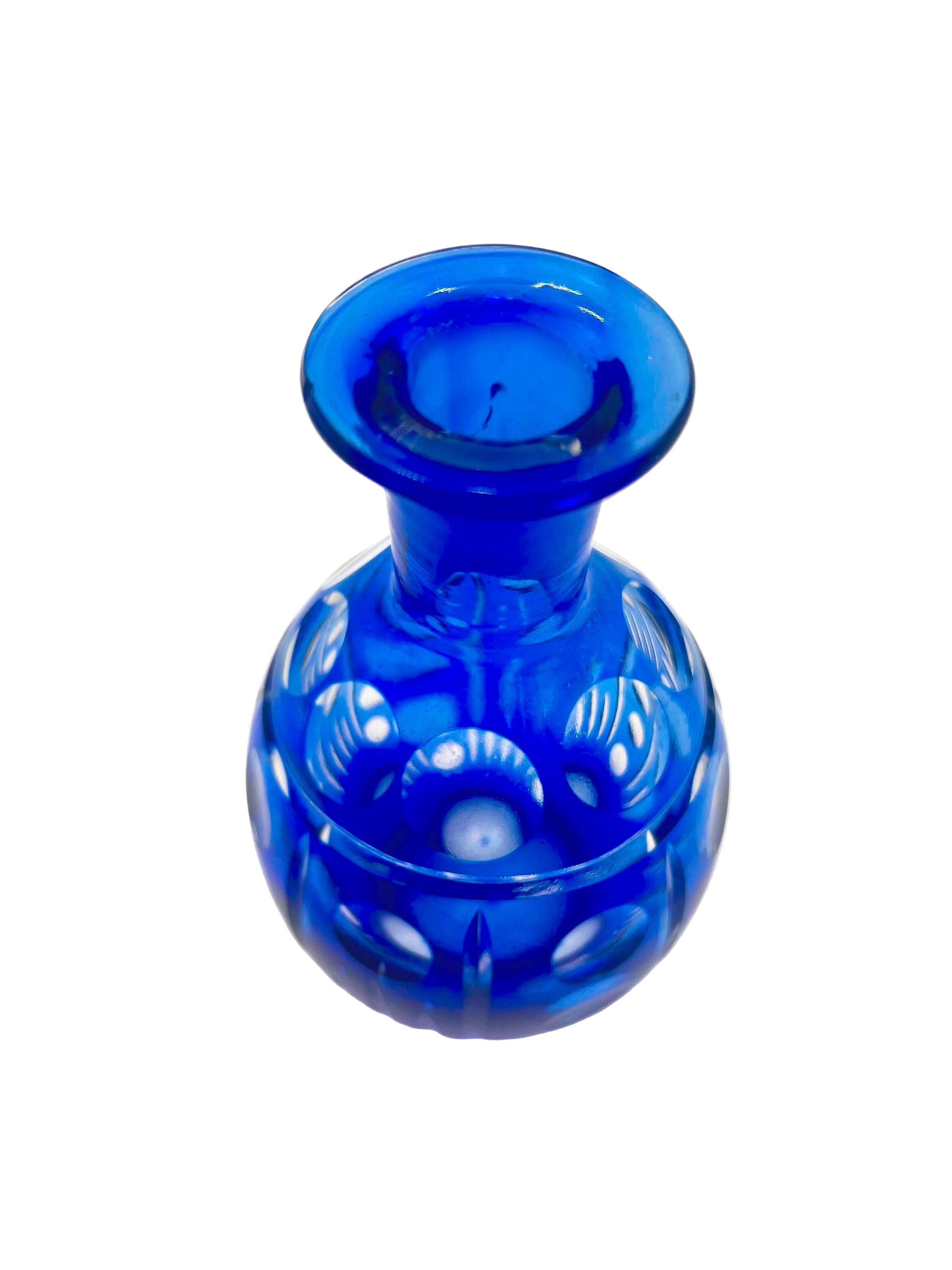 Minimalist mid-century modern decanter in a deep cobalt blue glass with a matching round stopper.
