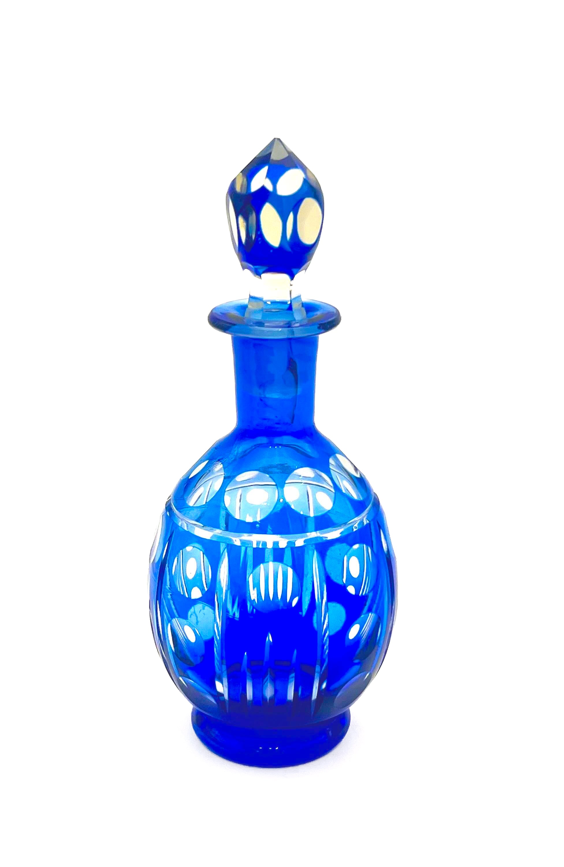 Minimalist mid-century modern decanter in a deep cobalt blue glass with a matching round stopper.